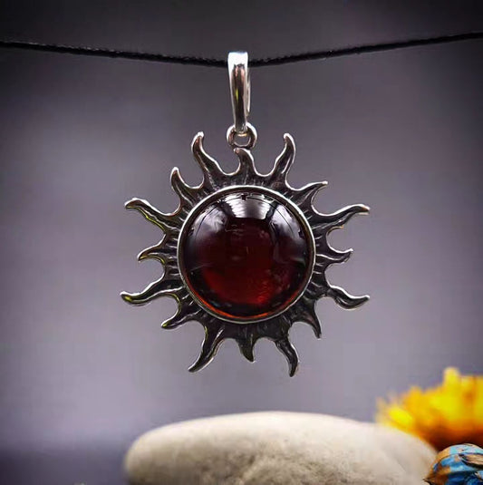 Amber Sun pendant made of blackened 925 sterling silver and red amber