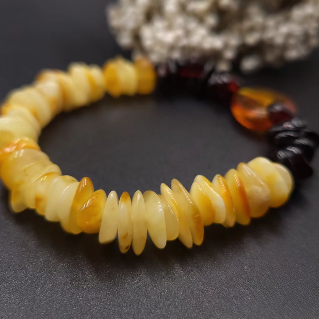 Polished cherry/dark cognac amber nuggets and the translucent honey oval centerpiece on the two-tone bracelet.