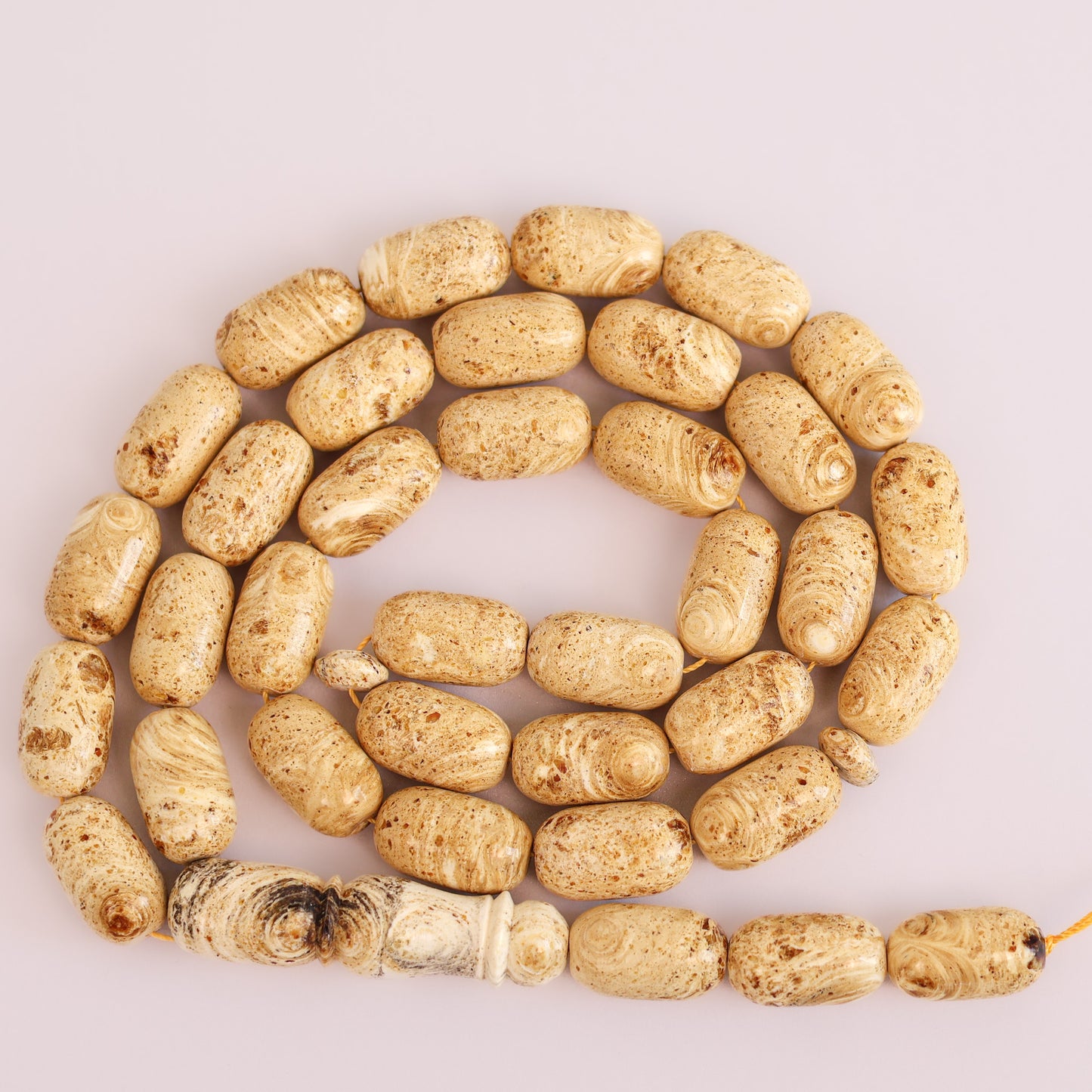 Detailed view of the prominent Imam bead and unique patterns of the genuine كهرمان طبيعي (natural amber) rosary.