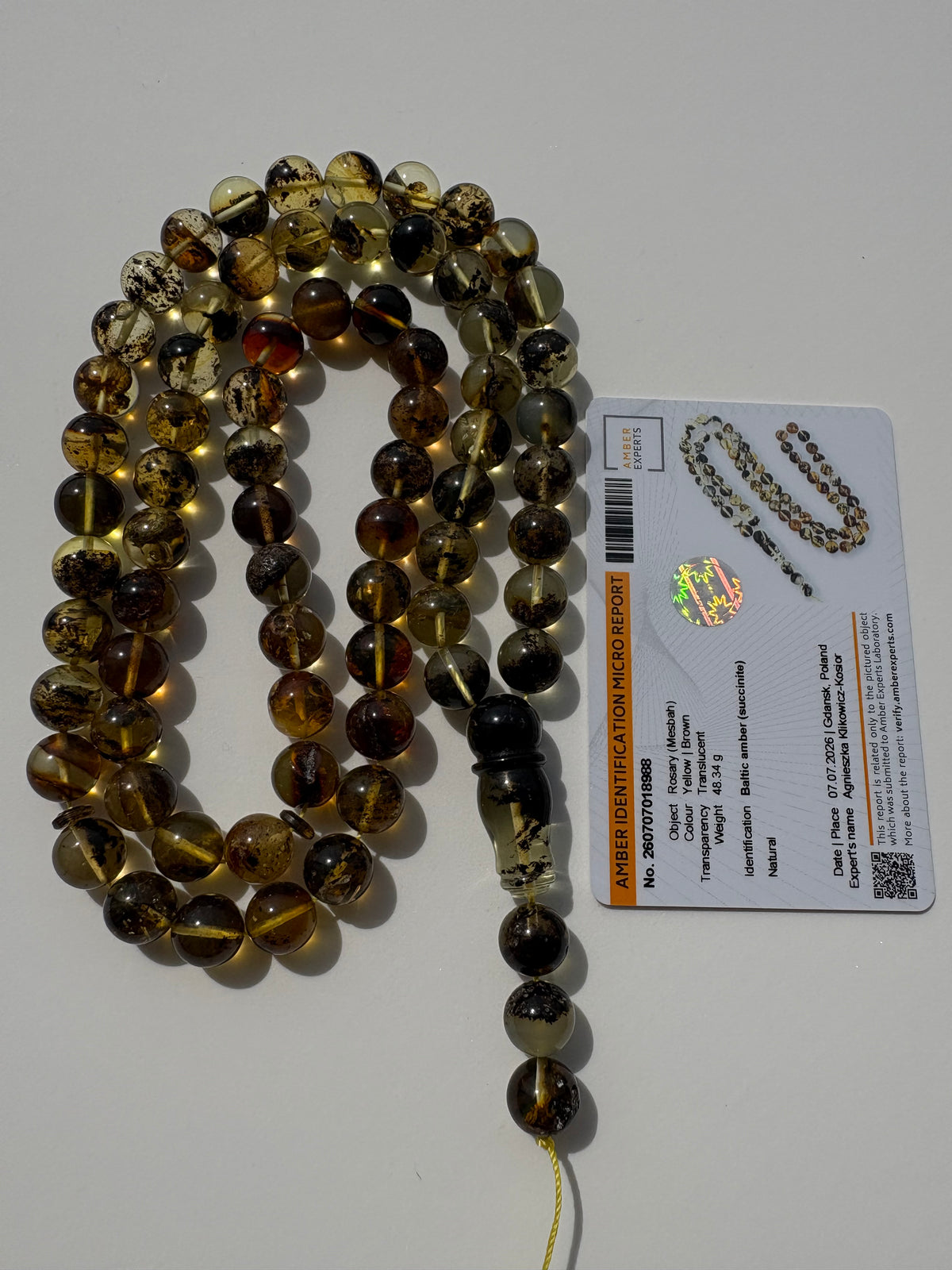 Tetibel genuine succinite amber prayer beads with natural inclusions.