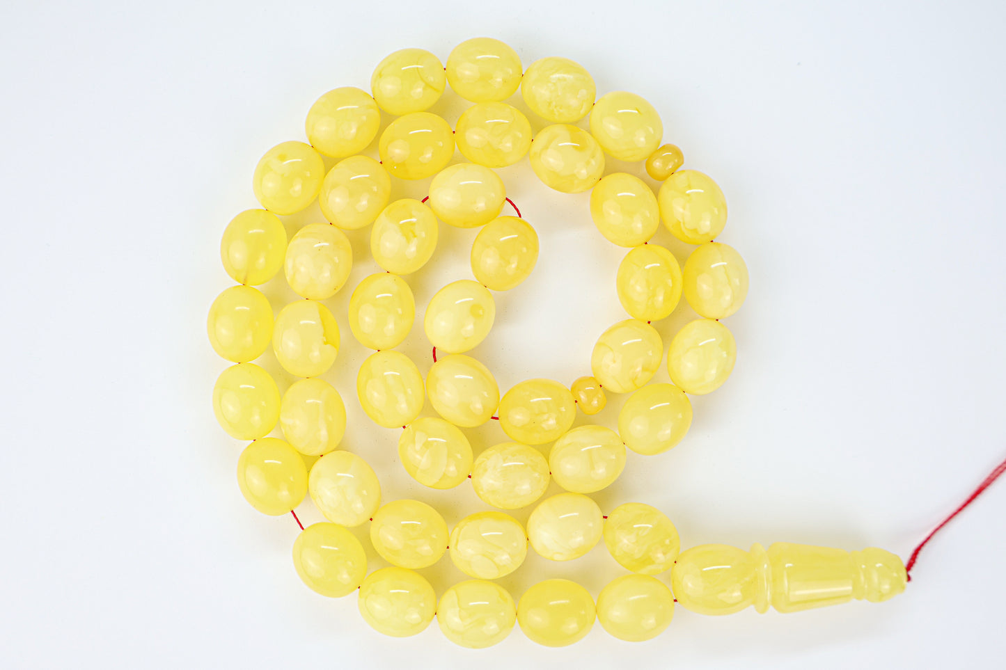 Laboratory certified natural Baltic amber rosary display with official report card from Tetibel Amber Jewels.
