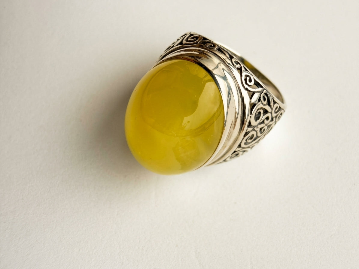 Authentic Baltic amber jewelry display showing an ornate filigree silver statement ring by Tetibel Amber Jewels.