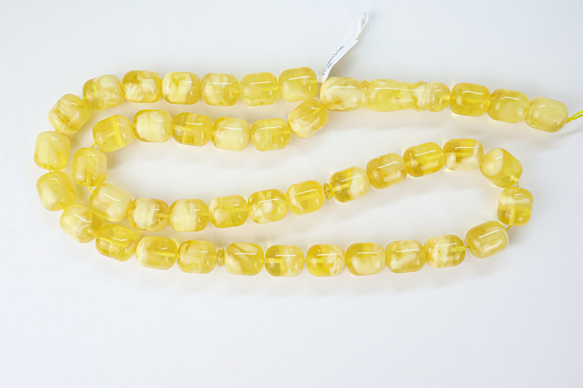 Authentic yellow-white Baltic amber misbaha strand displaying milky white and honey yellow patterns.