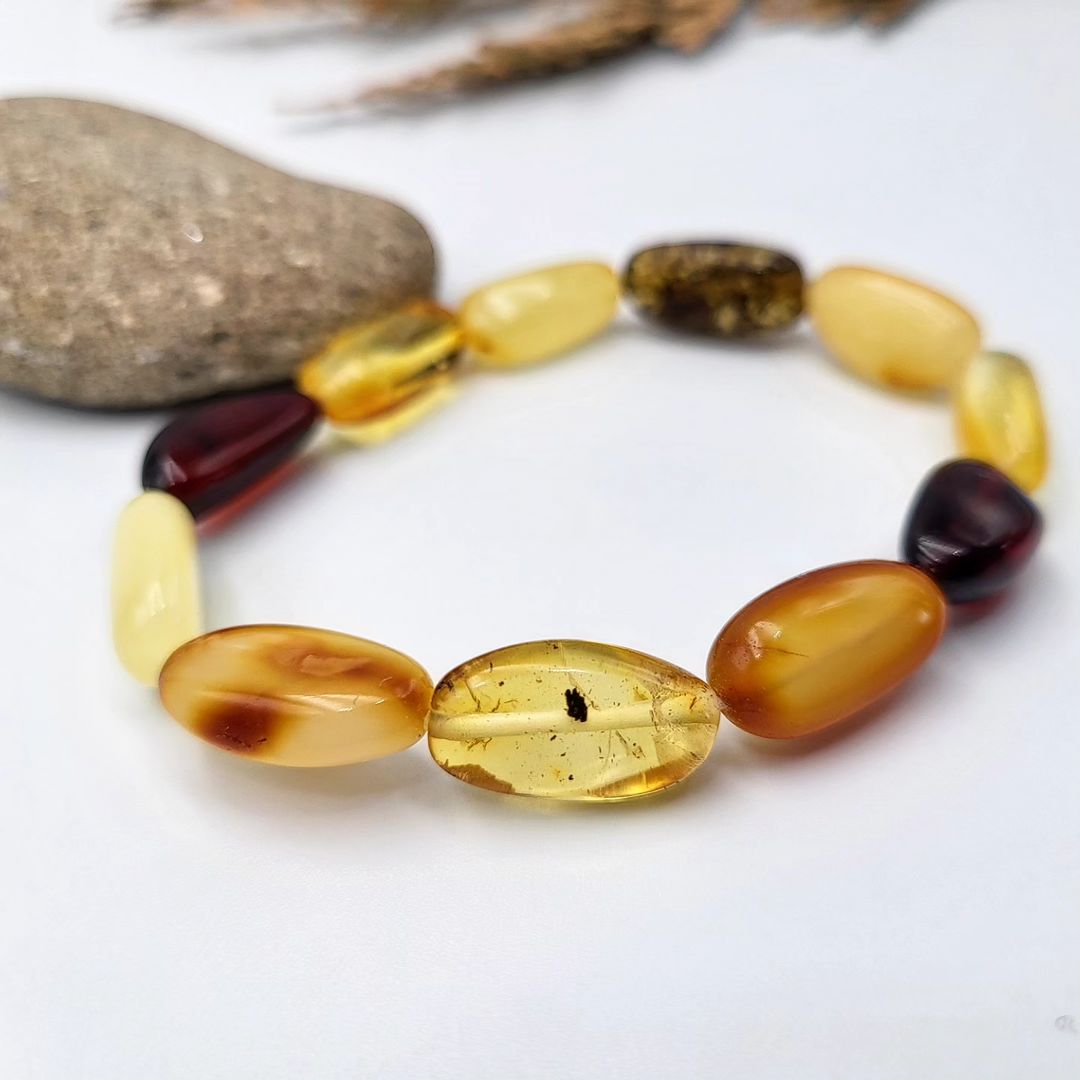 multi-color Baltic amber olive beads, highlighting natural clarity and subtle inclusions.