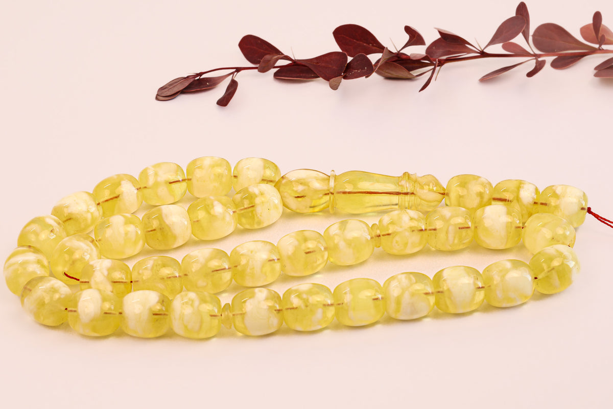 Close-up of certified Baltic amber Tesbih (سبحة كهرمان بلطيقي). Features opaque, milky yellow succinite beads.