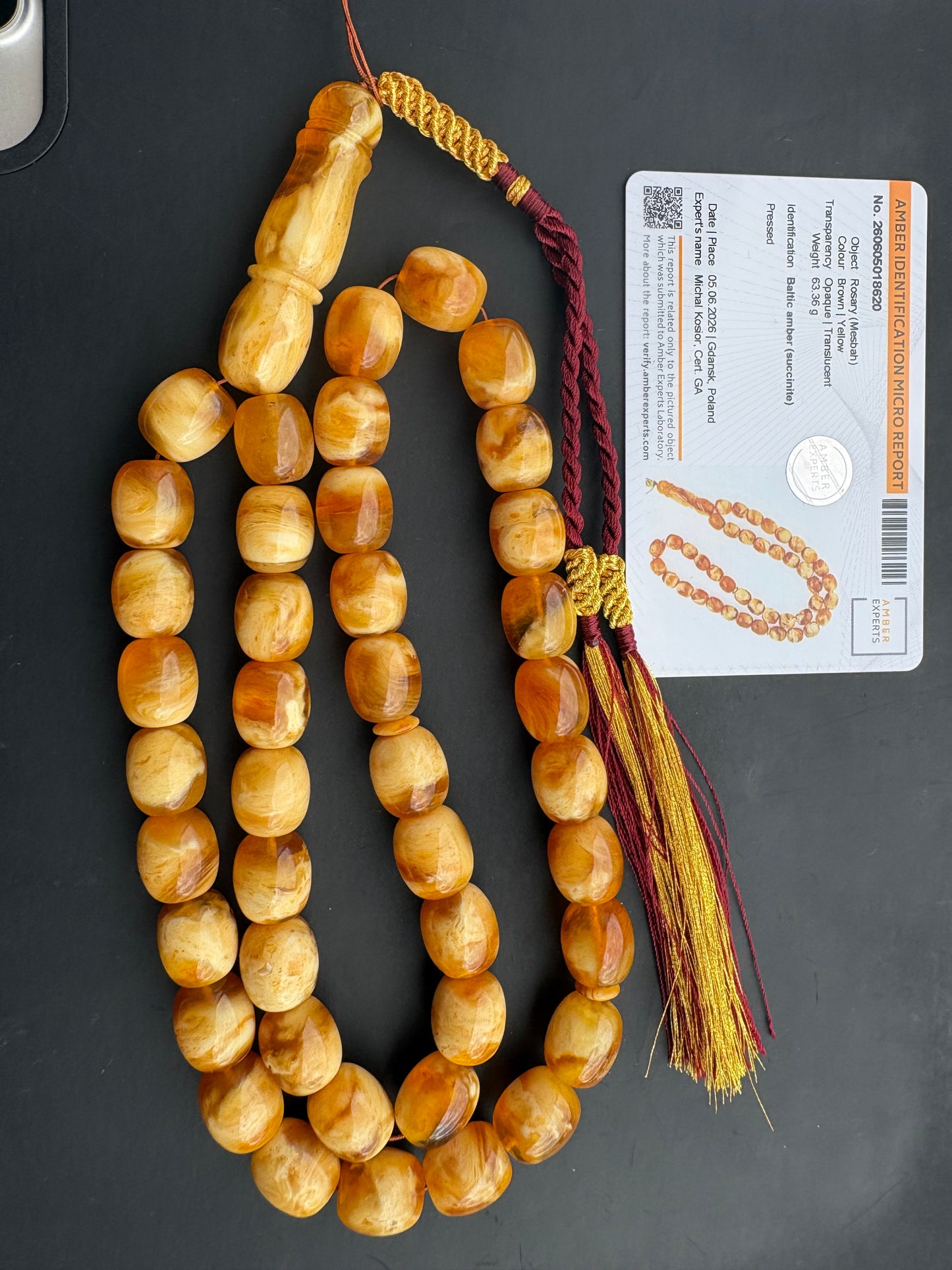 Tetibel 42-bead pressed Baltic amber rosary with 13.5x12mm brown-yellow barrel beads and a custom handmade burgundy and gold tassel from Doha.