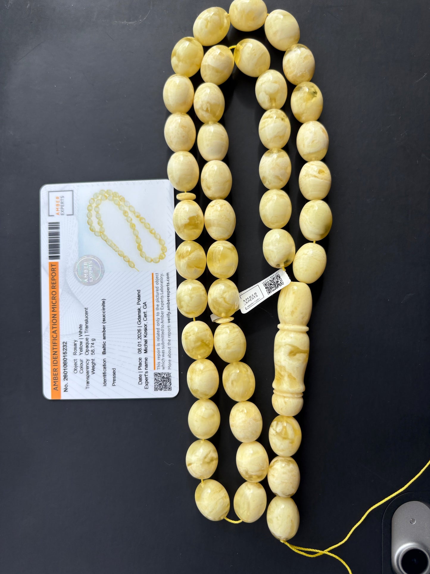 Tetibel 42-bead pressed Baltic amber rosary with 15x12mm yellow and white marbled oval beads alongside its official authenticity micro report.