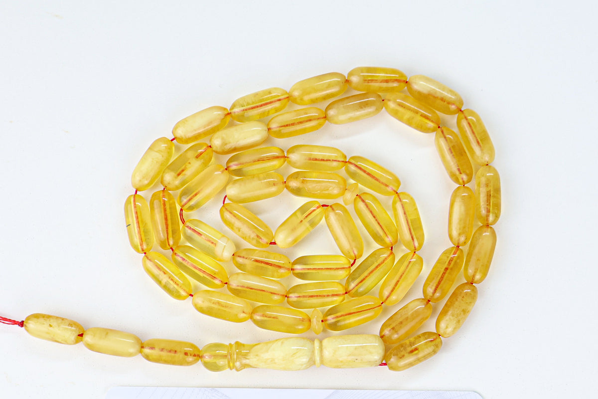 Handcrafted yellow succinite amber tasbih featuring 48 authentic 13.5x6mm pressed beads, weight 16.58 grams.