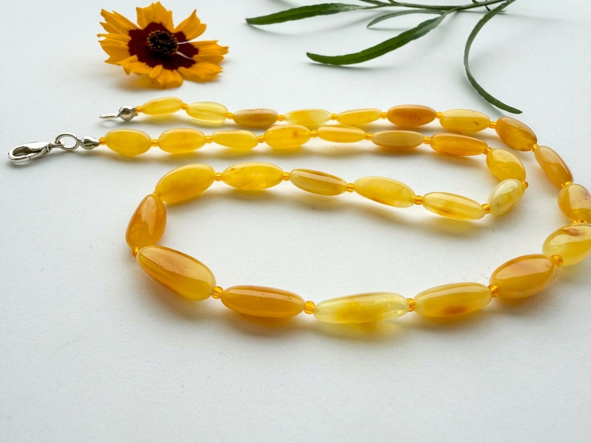 Yellow amber bead necklace with silver lobster clasp.