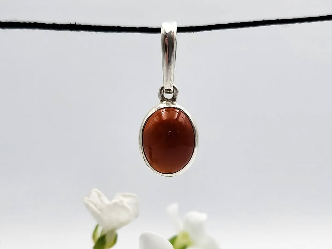 Close-up of genuine Baltic amber oval cabochon in silver setting