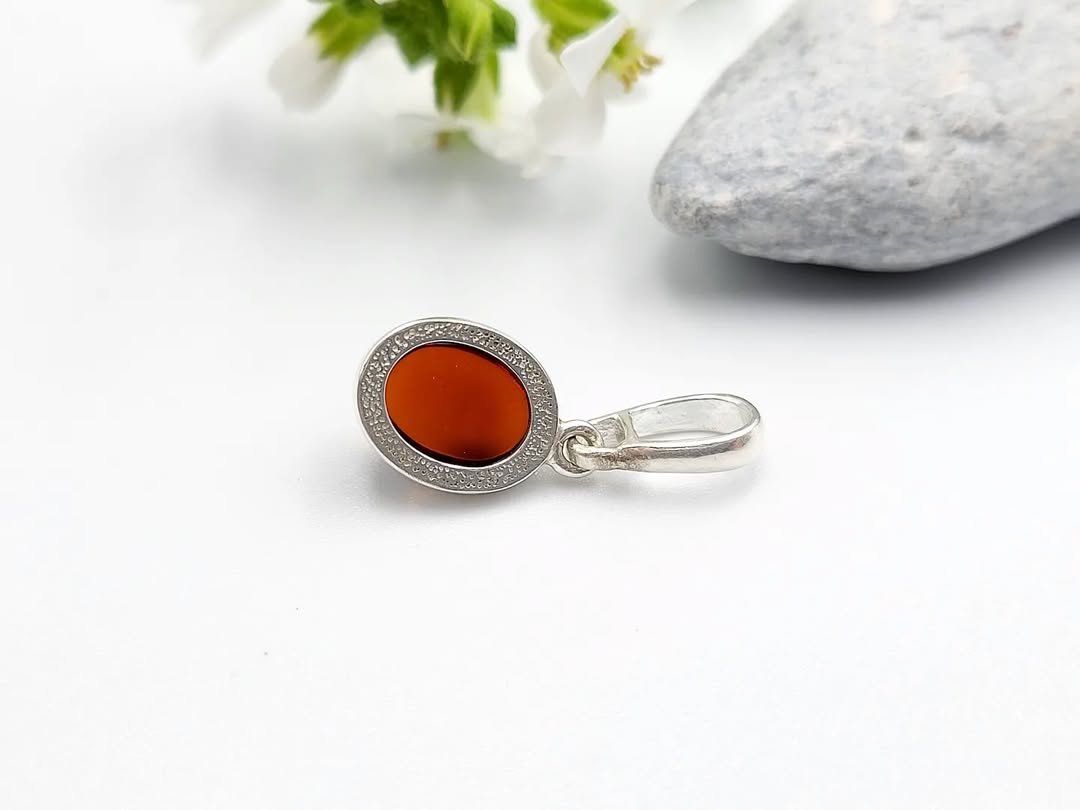 Cognac Baltic amber oval pendant in silver