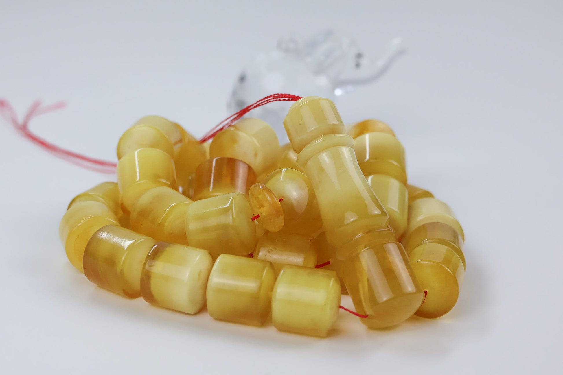 butterscotch pressed Baltic amber barrel beads showing natural marbling and polish finish