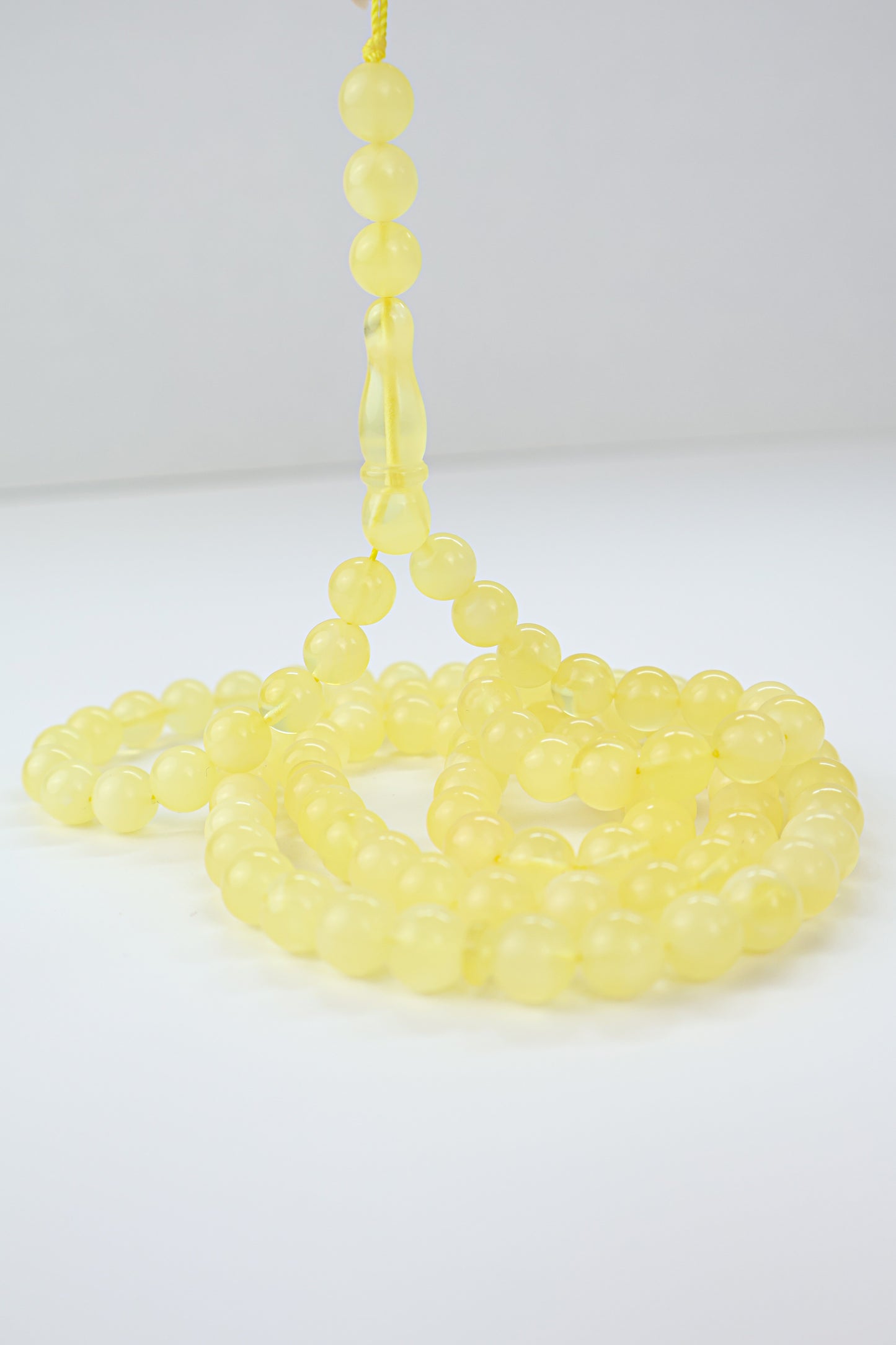 Handcrafted yellow succinite amber tasbih featuring 102 authentic 8mm round beads, weight 29.72 grams.