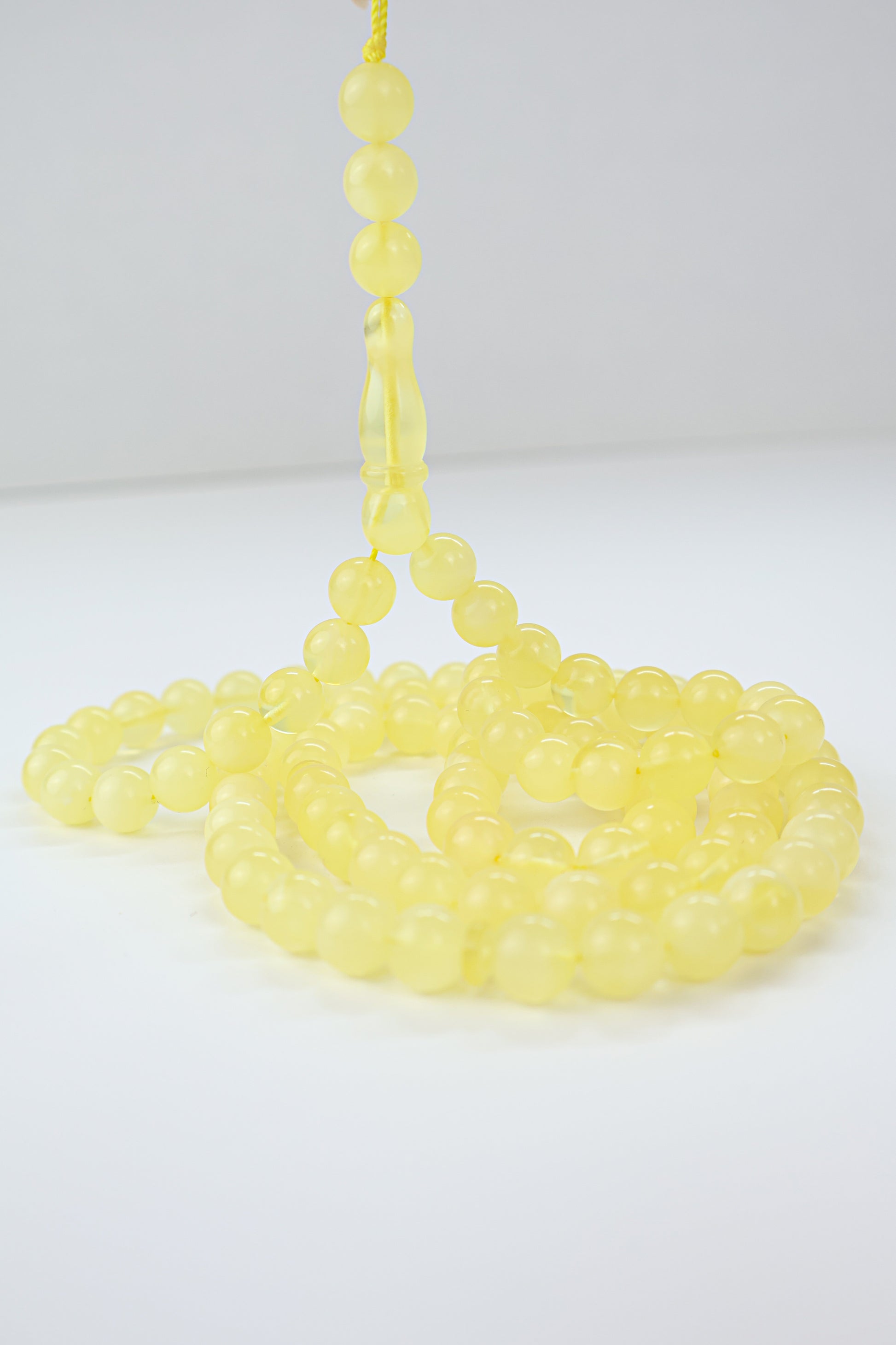 Handcrafted yellow succinite amber tasbih featuring 102 authentic 8mm round beads, weight 29.72 grams.
