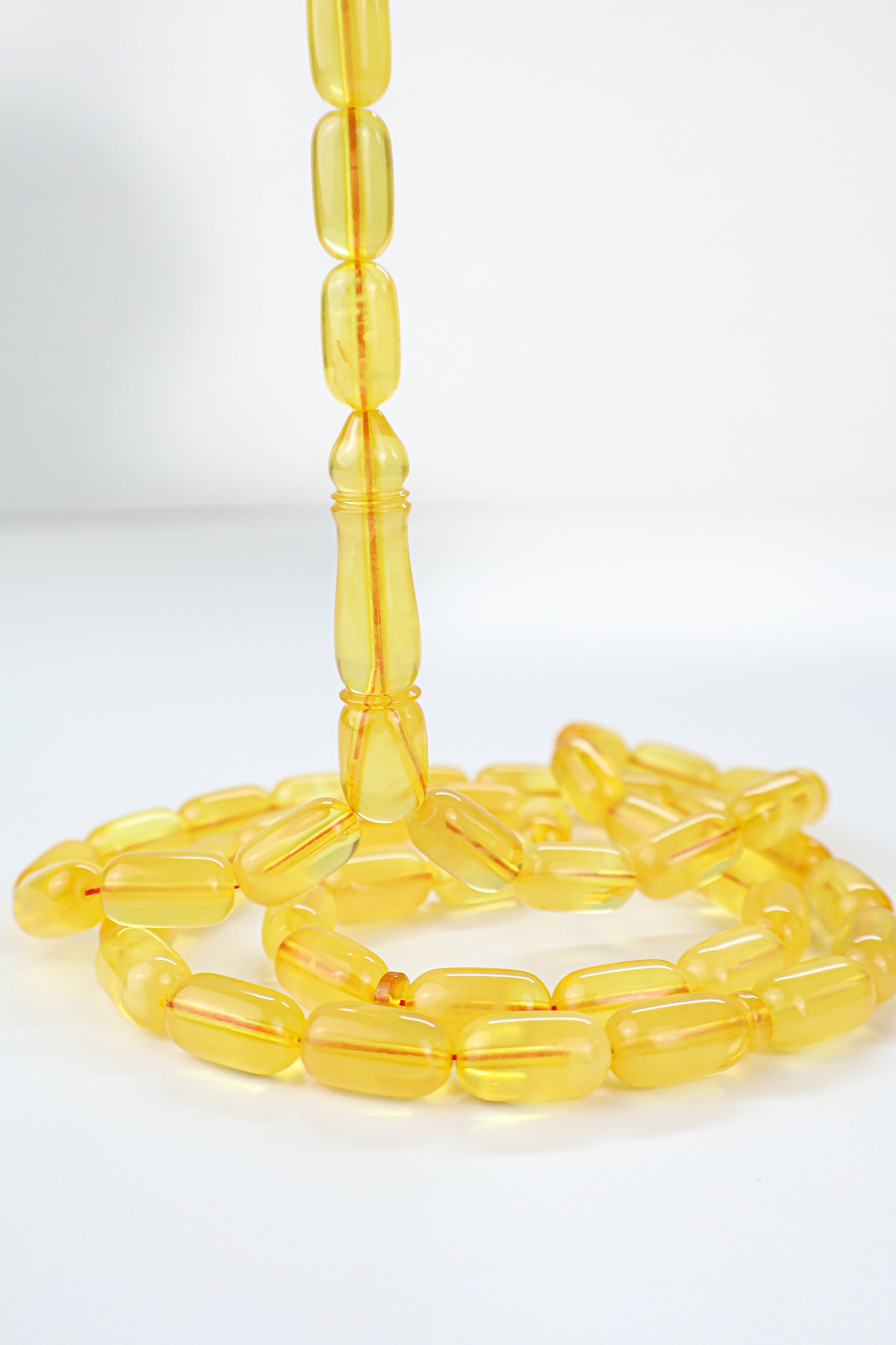 Handcrafted dark yellow succinite amber tasbih featuring 48 authentic 14.5x8mm beads, weight 35.20 grams.