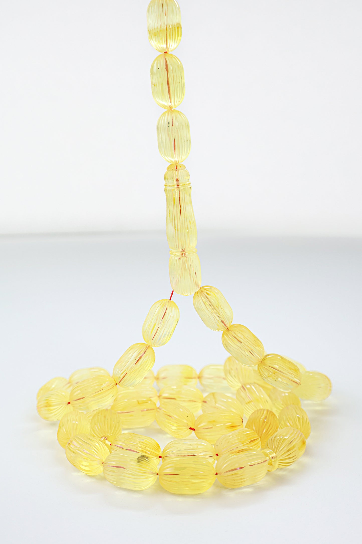 Handcrafted yellow succinite amber tasbih featuring 42 authentic 16.5x10mm handmade carved beads, weight 47.22 grams.