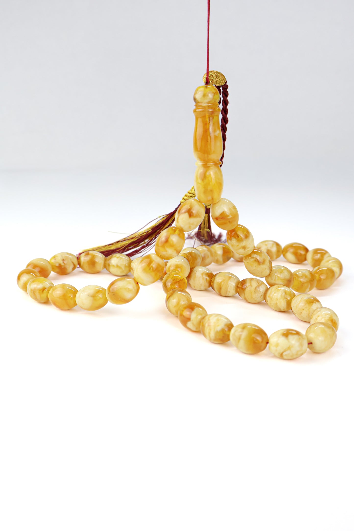 Pressed Baltic amber prayer beads 42 beads 15x12mm 59.66g with handmade burgundy and gold Doha Qatar tassel  from Tetibel Amber Jewels