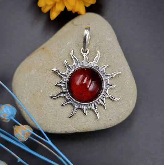 Baltic amber sun pendant in silver with deep cognac stone