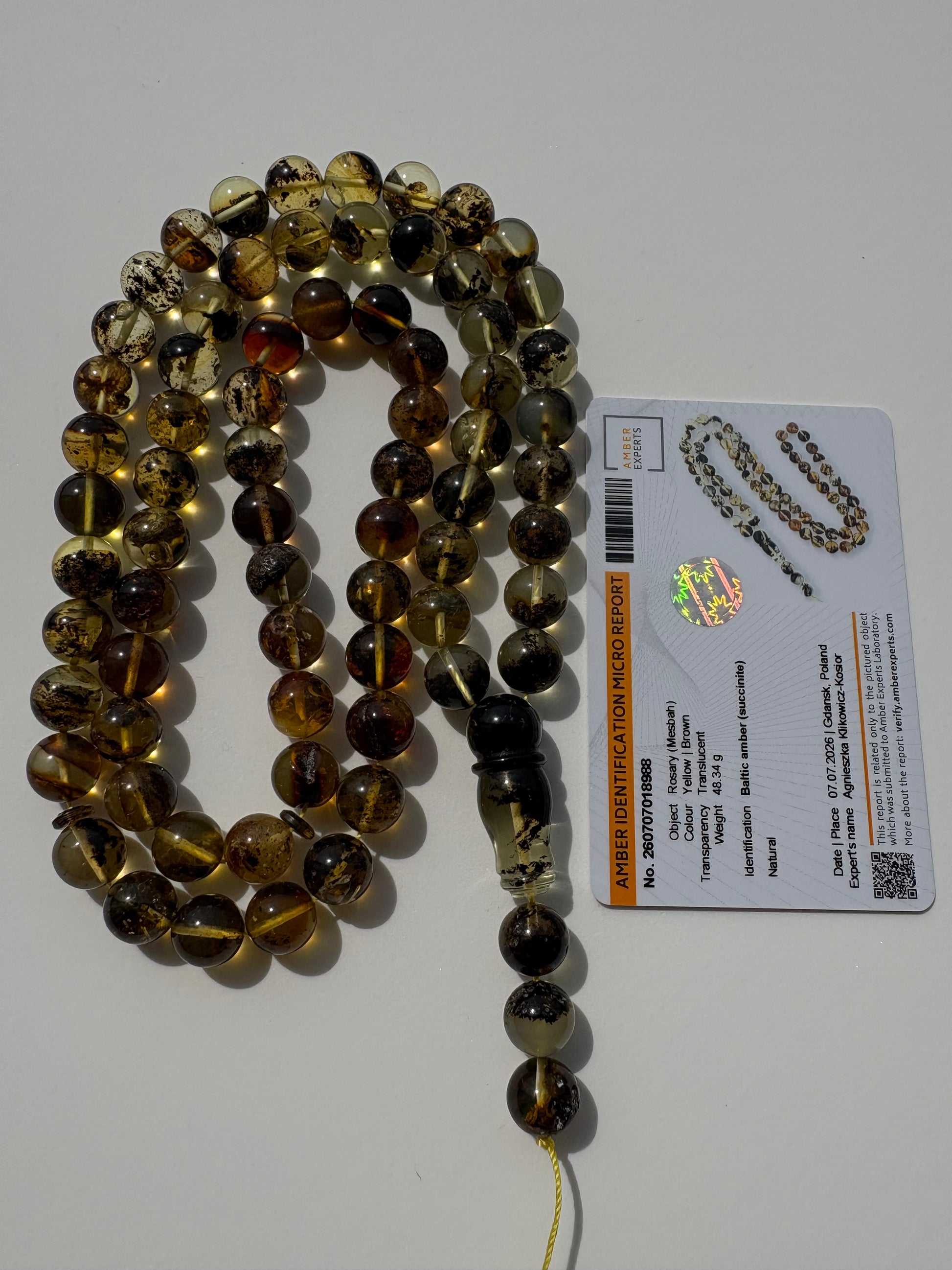 Tetibel genuine succinite amber prayer beads with natural inclusions.
