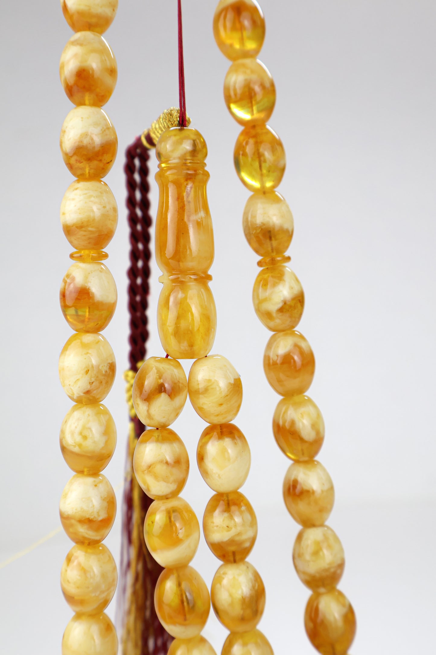 Pressed Baltic amber prayer beads 42 beads 15x12mm 59.66g with handmade burgundy and gold Doha Qatar tassel and lab certificate from Tetibel Amber Jewels