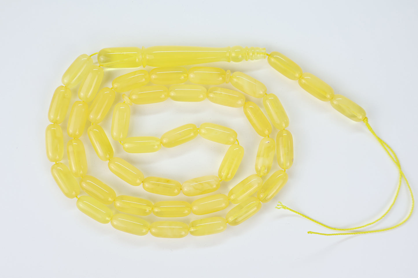 Handcrafted yellow succinite amber tasbih featuring 42 authentic 16x7mm beads and 71mm imam piece, weight 28.65 grams.