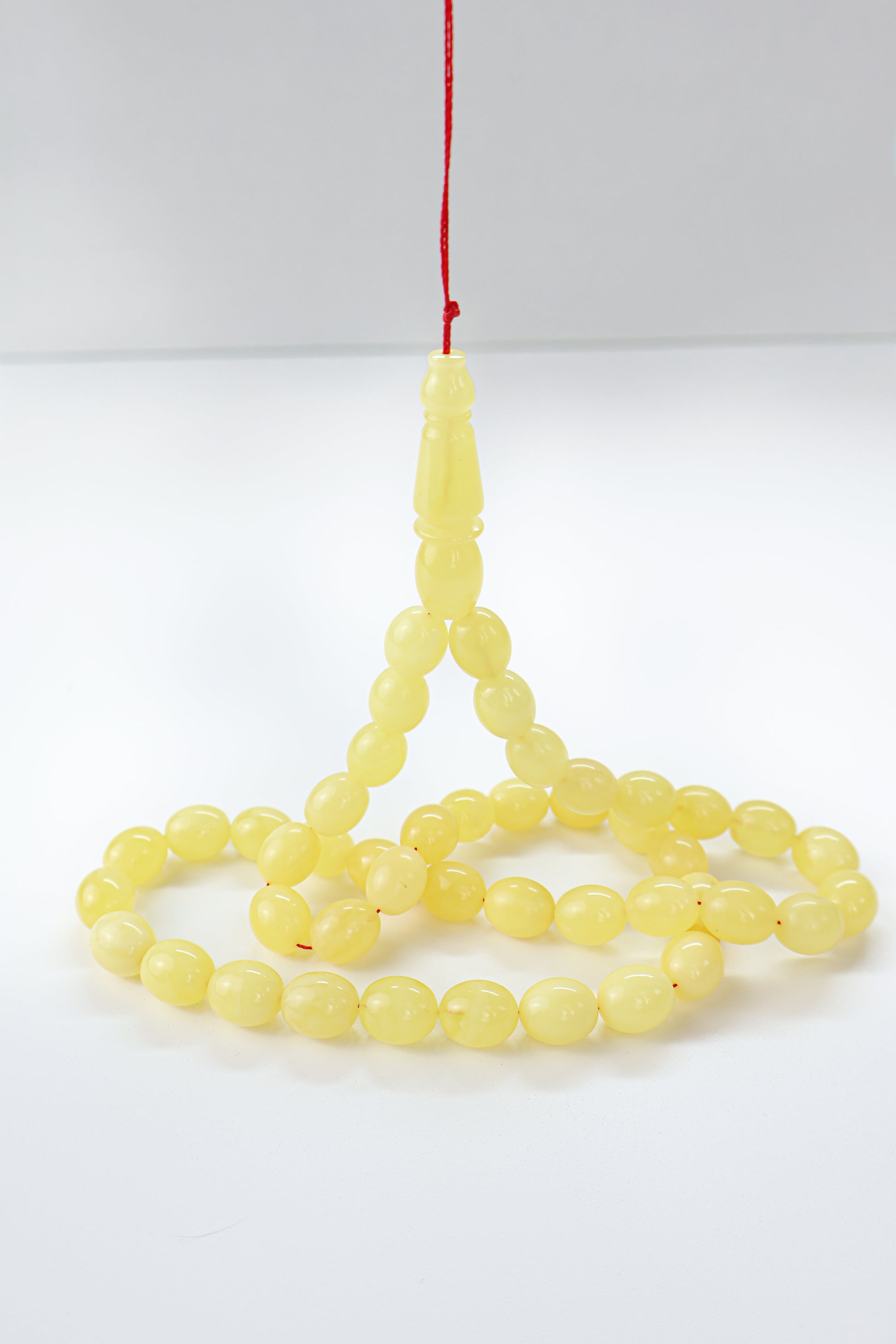 Certified natural opaque yellow Baltic amber misbaha rosary with 45 beads measuring 12x9.7 mm by Tetibel.