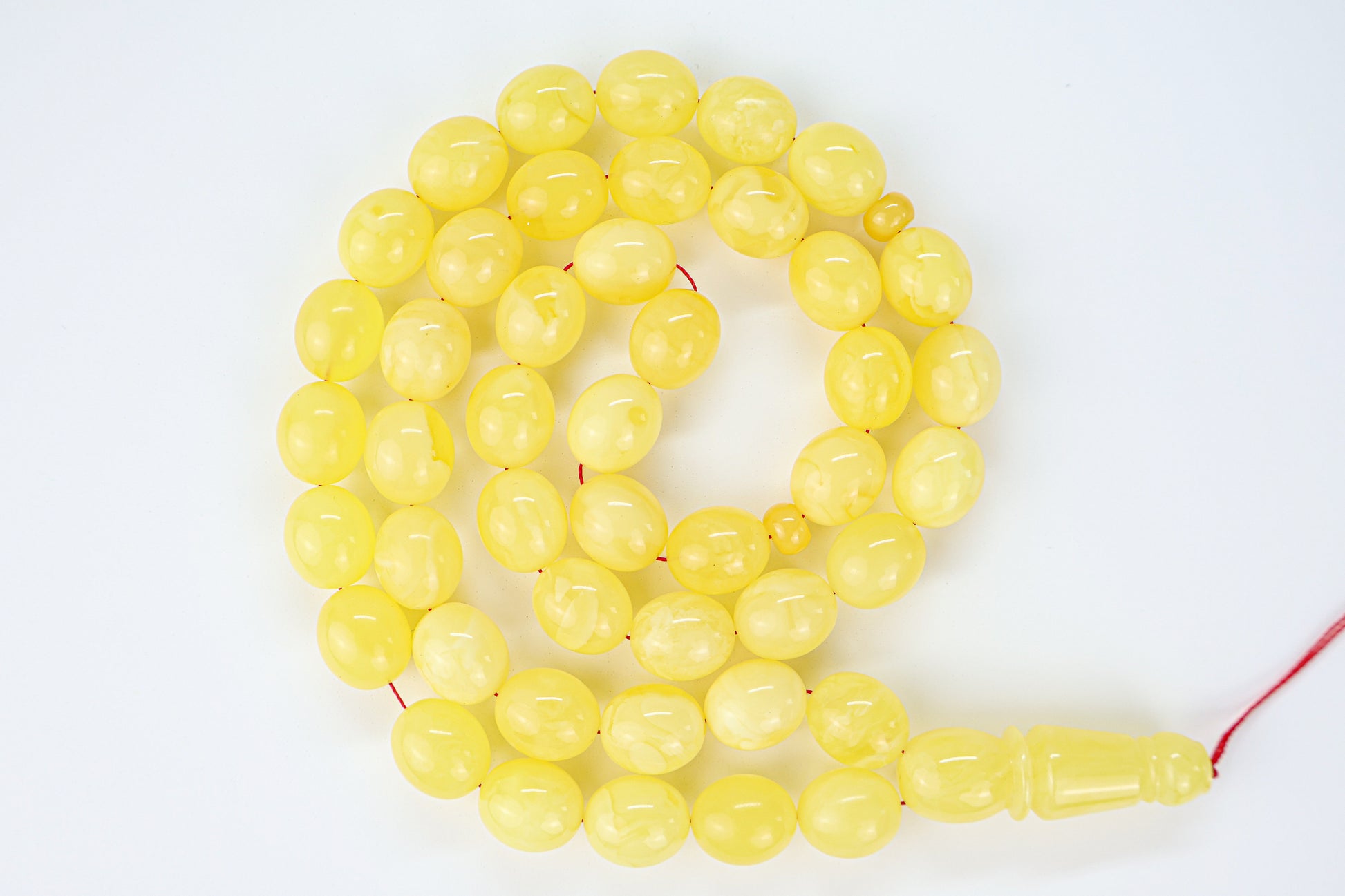 Laboratory certified natural Baltic amber rosary display with official report card from Tetibel Amber Jewels.