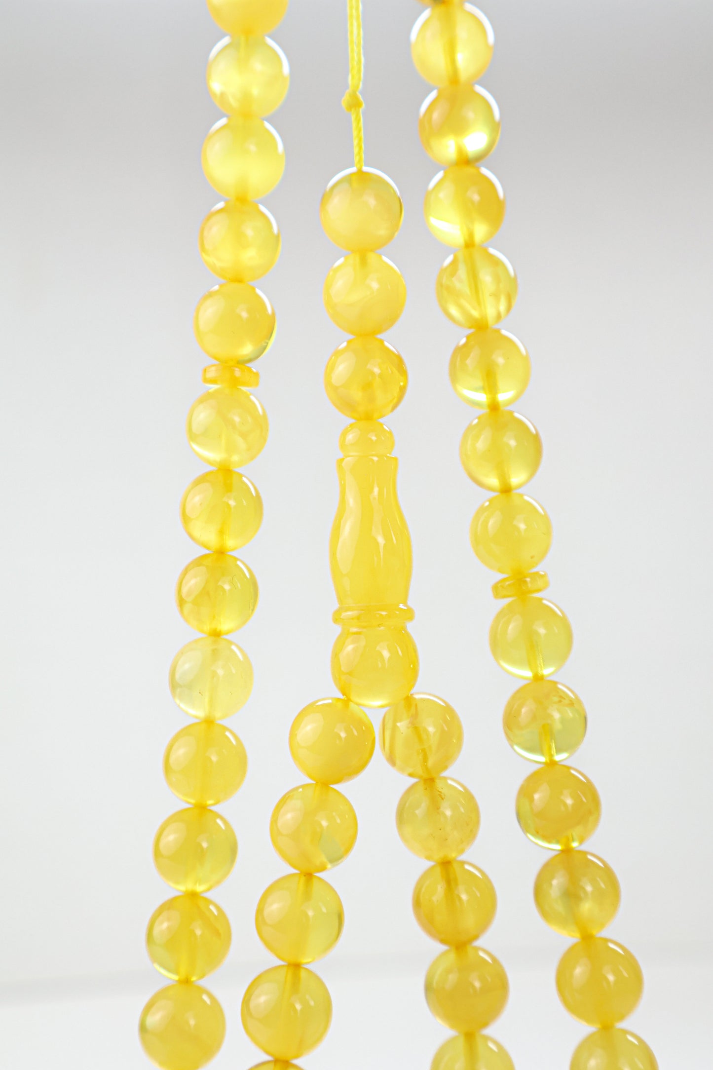 Laboratory certified natural Baltic amber rosary display with official report card from Tetibel Amber Jewels.