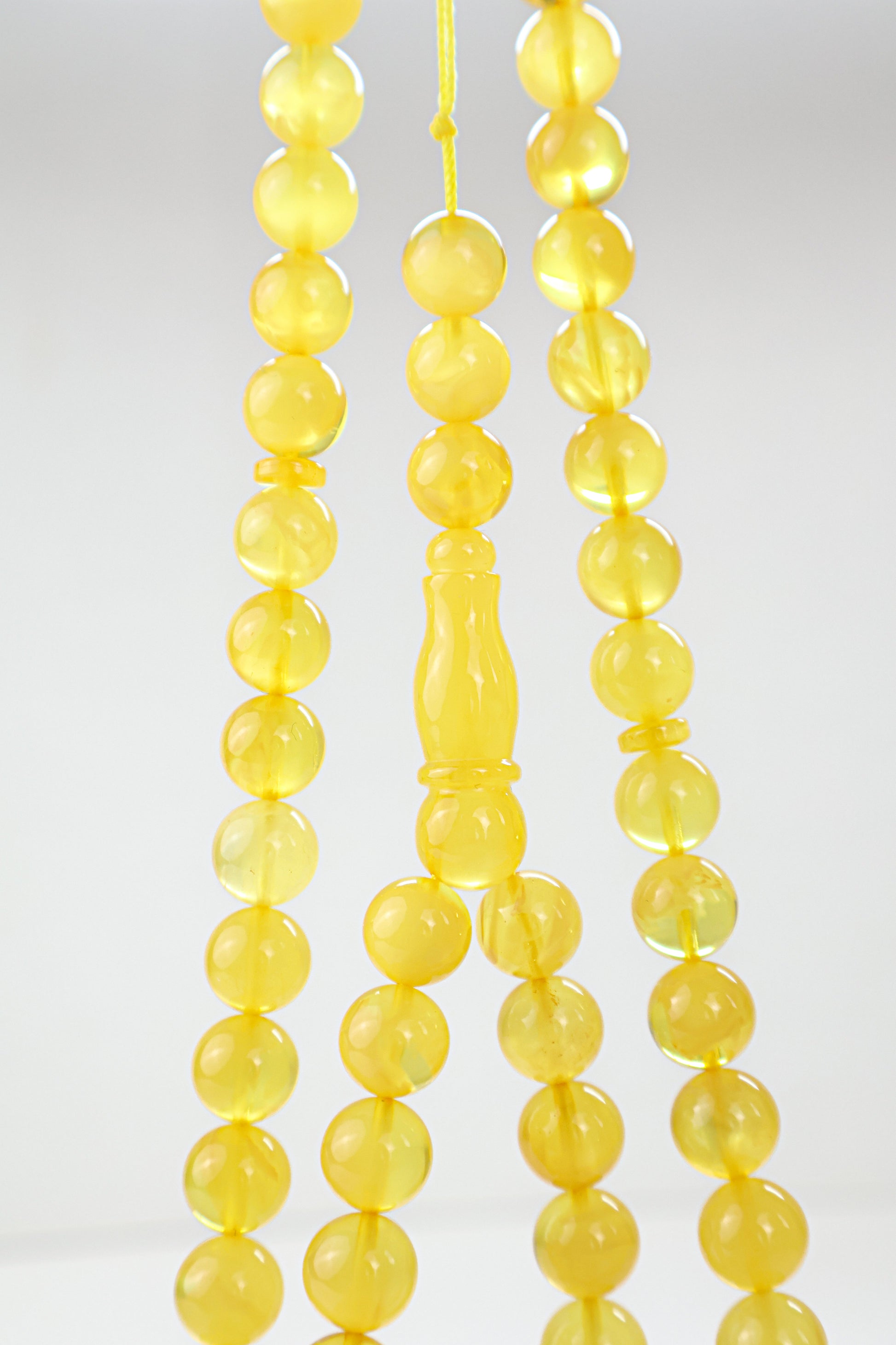 Laboratory certified natural Baltic amber rosary display with official report card from Tetibel Amber Jewels.