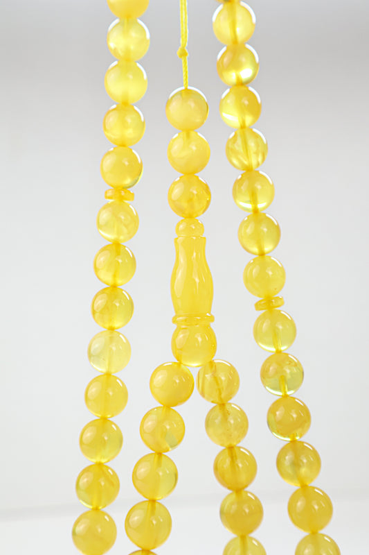 Laboratory certified natural Baltic amber rosary display with official report card from Tetibel Amber Jewels.