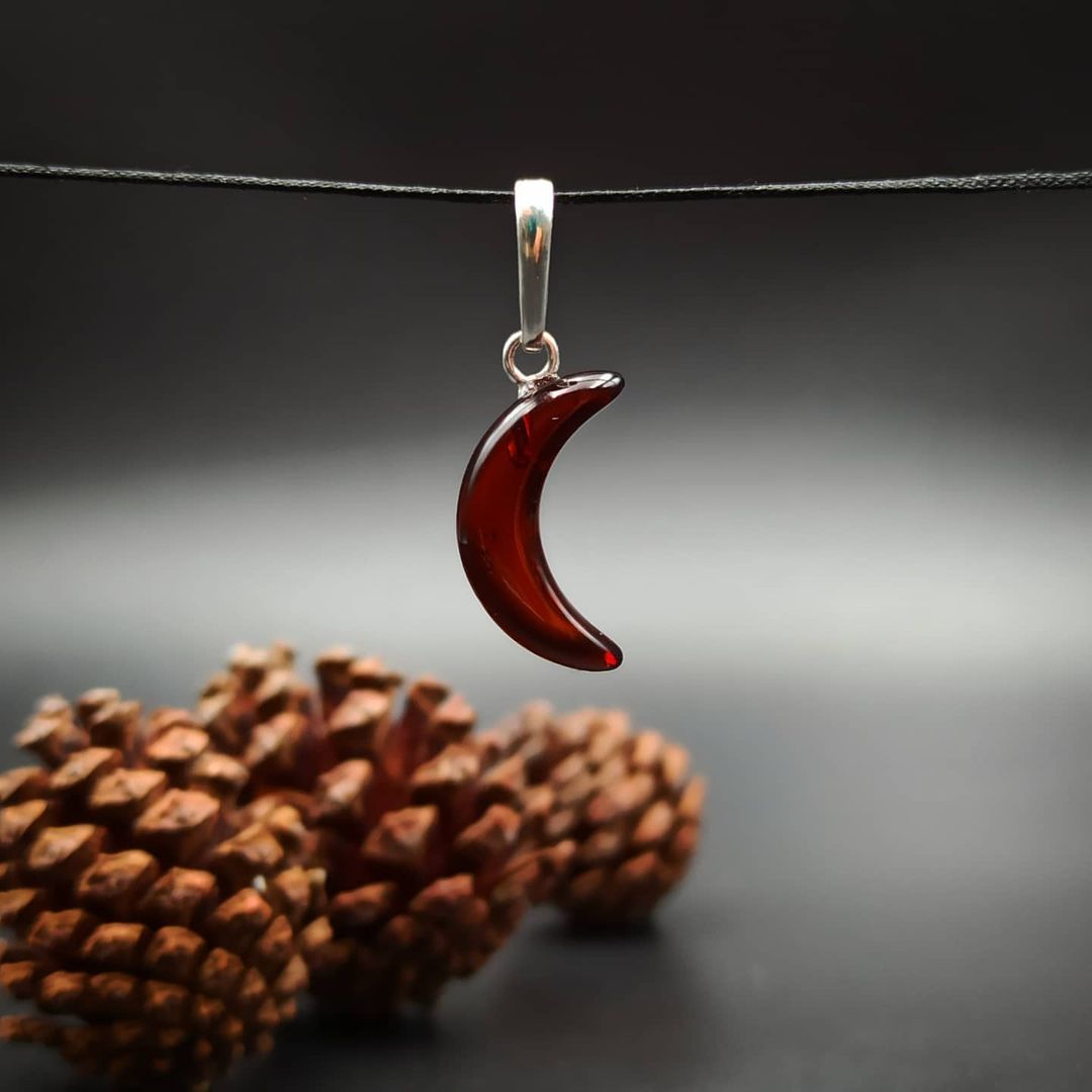 Deep cognac Baltic amber crescent moon pendant in silver