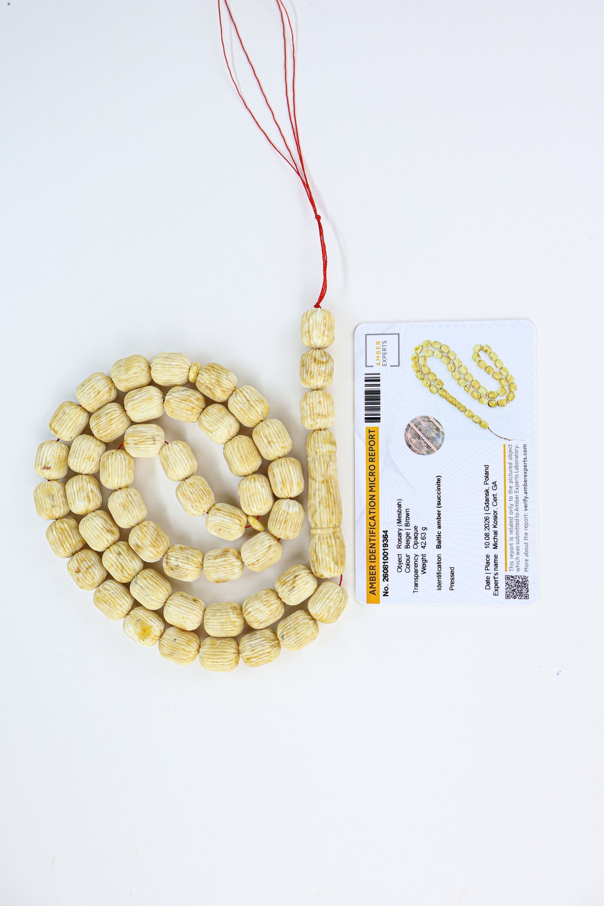 Laboratory certified Baltic amber rosary display with official micro report card from Tetibel Amber Jewels.