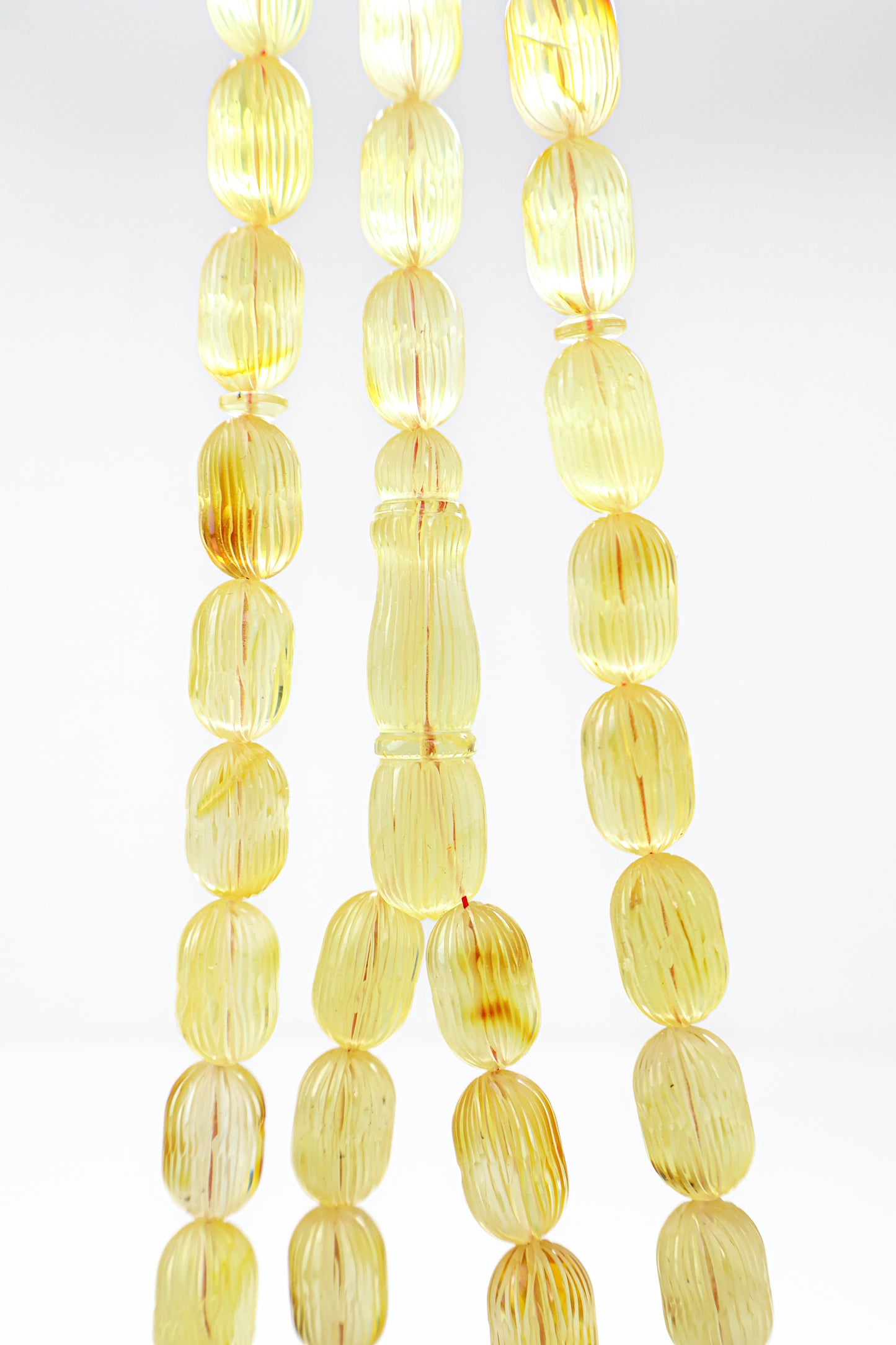 Handcrafted yellow and brown succinite amber tasbih featuring 42 authentic 16.3x10.2mm handmade carved beads with natural inclusions, weight 46.71 grams.