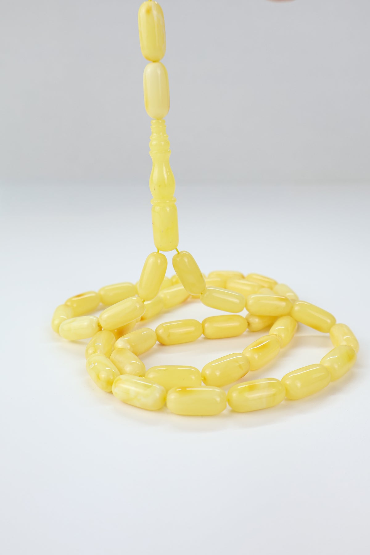 Authentic opaque yellow-orange Baltic amber misbaha strand complete with traditional amber imam.