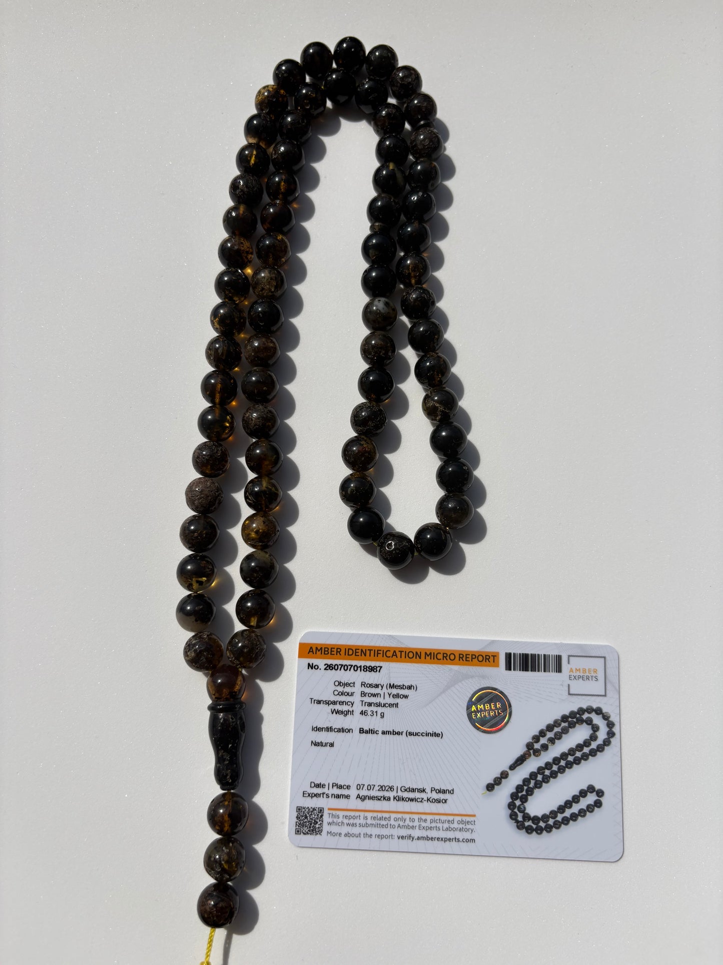 Natural Baltic amber rosary with 72 translucent brown and honey amber beads measuring 10.4 mm.