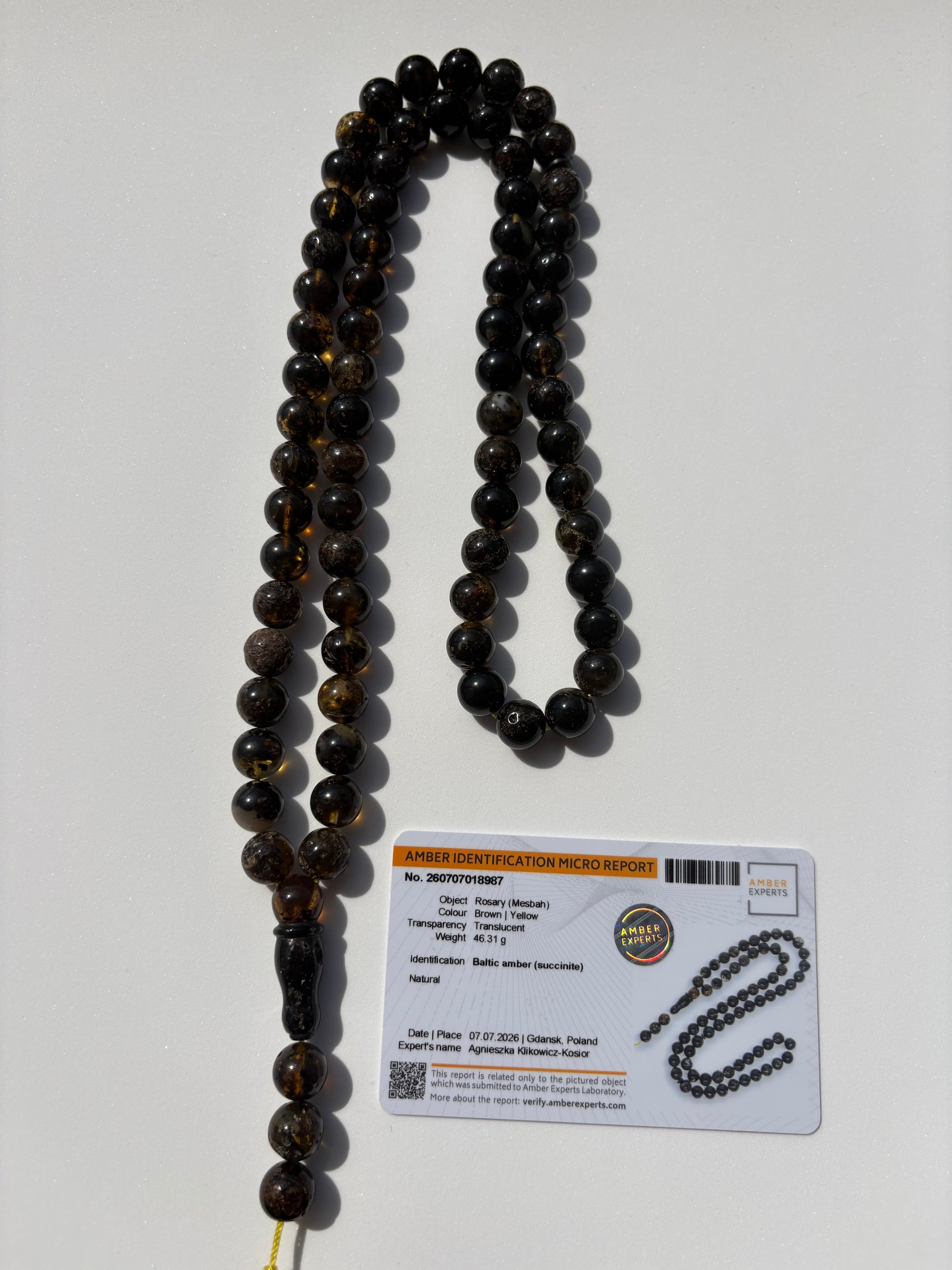 Natural Baltic amber rosary with 72 translucent brown and honey amber beads measuring 10.4 mm.