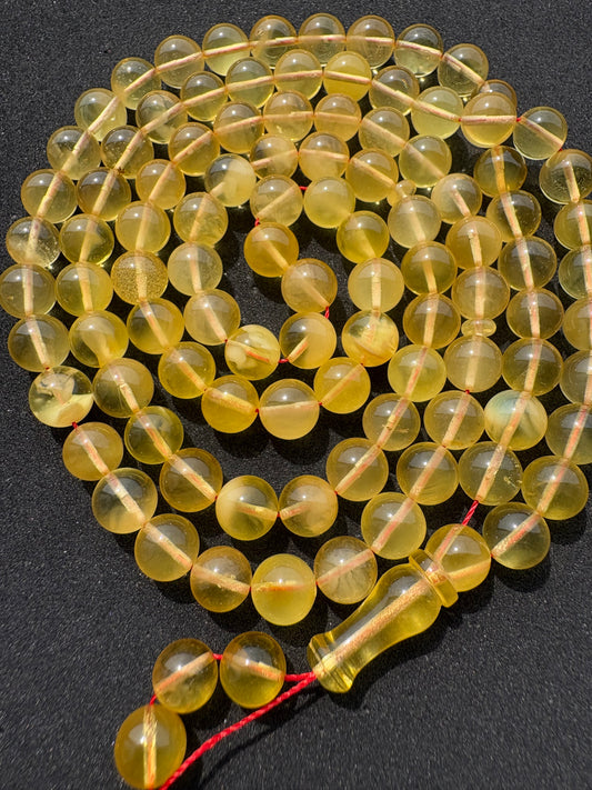 Natural Baltic amber Tesbih with 102 transparent round lemon-yellow amber beads.