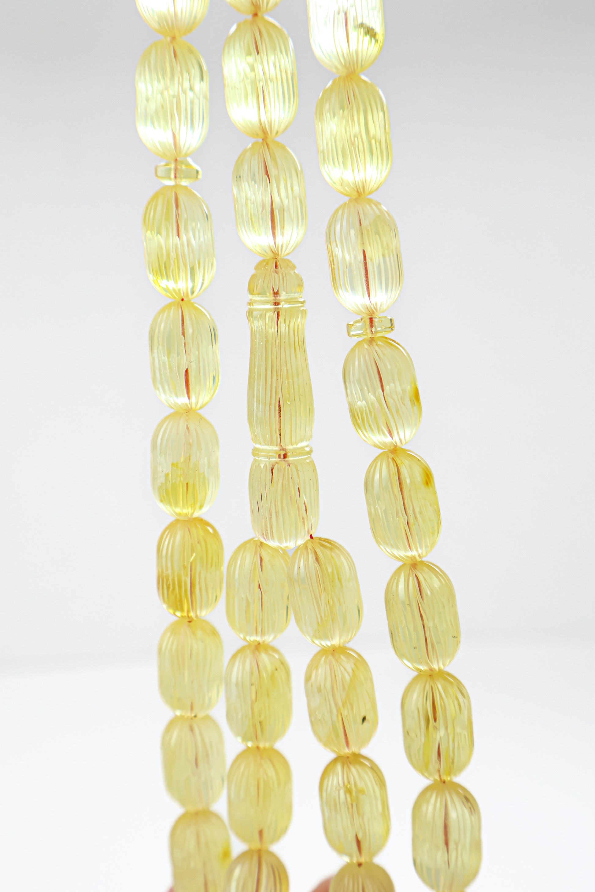 Certified natural hand-carved translucent yellow Baltic amber misbaha rosary with 42 beads measuring 16.5x10 mm by Tetibel.