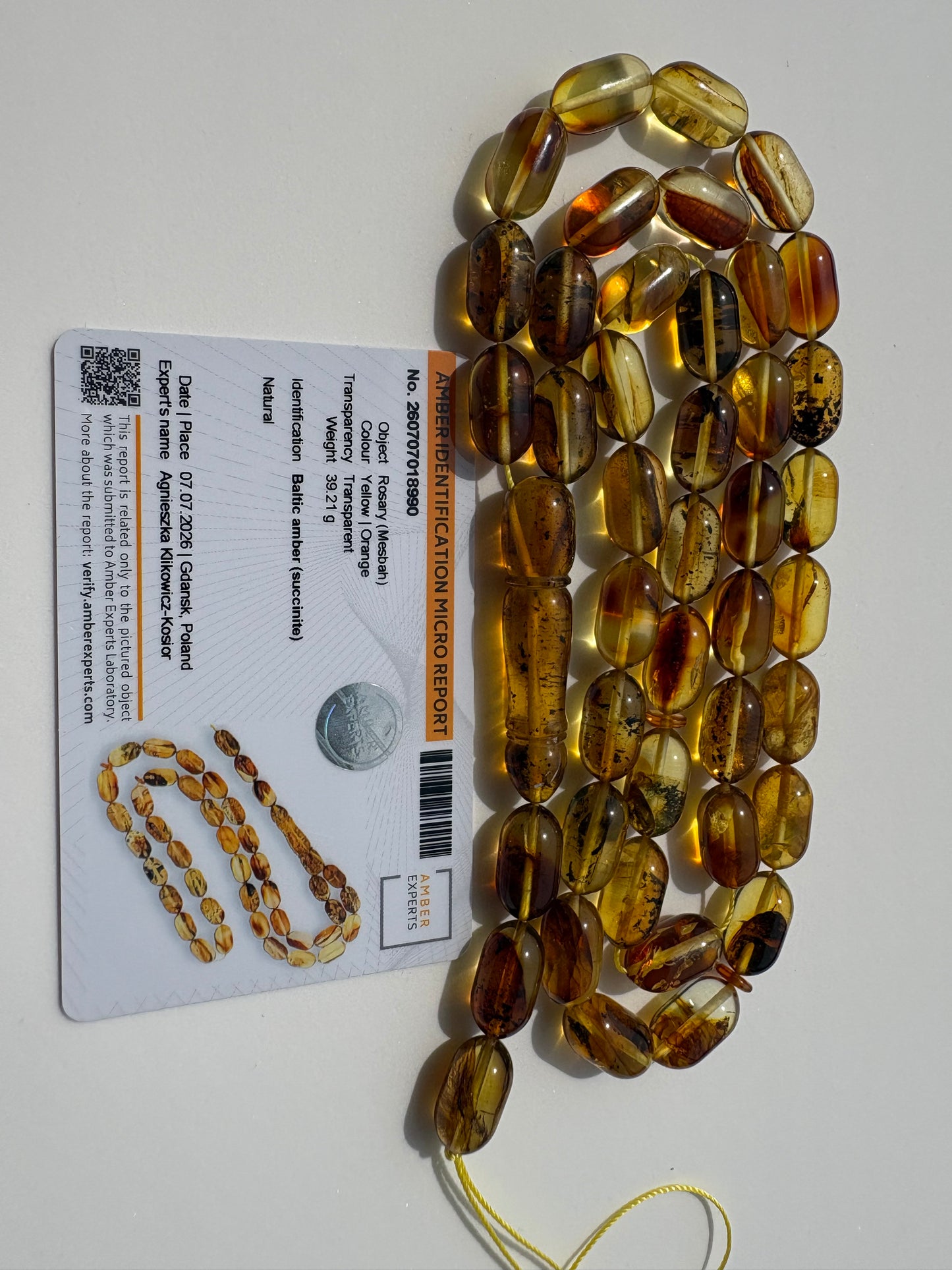 Genuine succinite amber prayer beads with transparent natural inclusions.