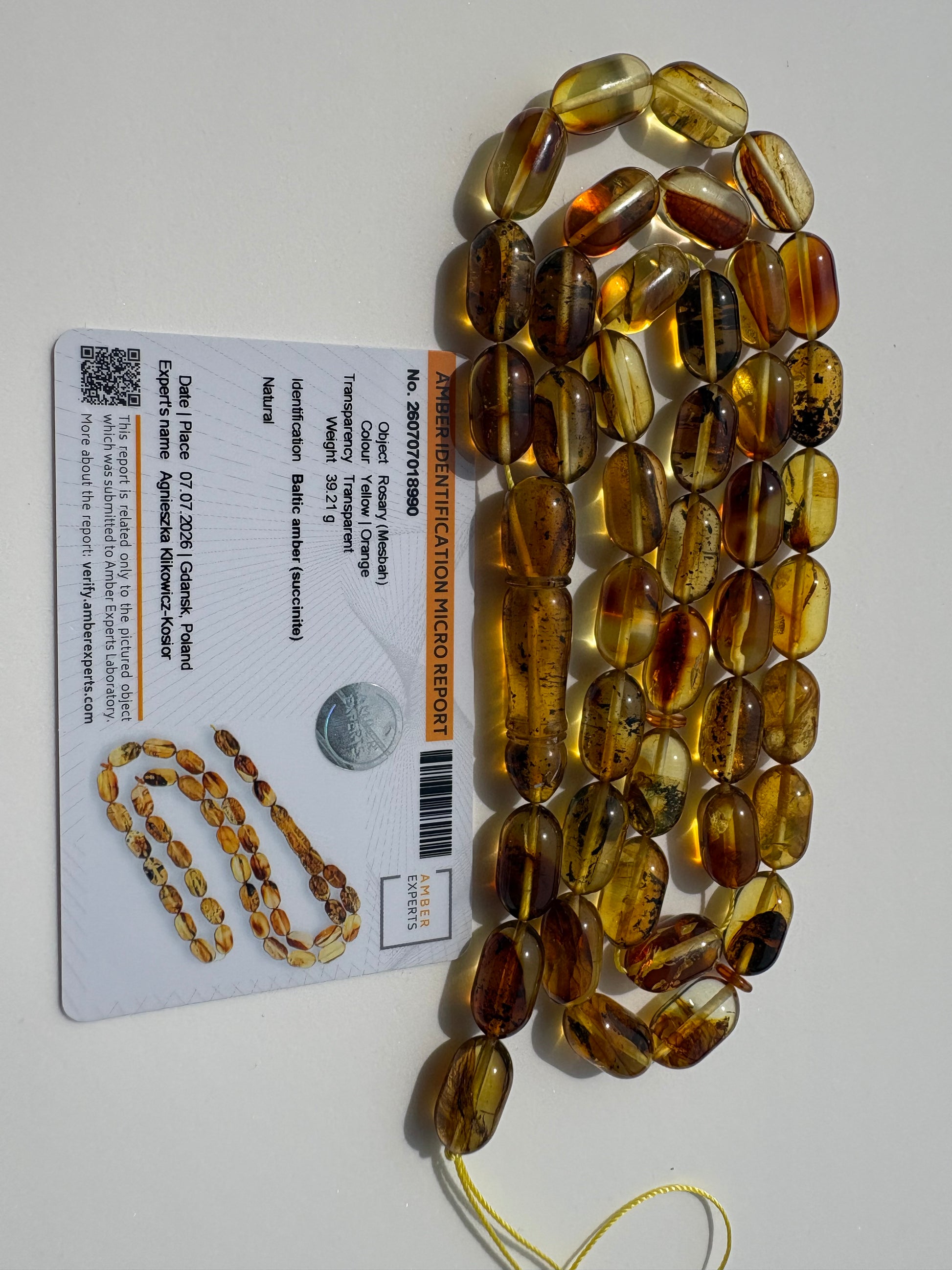 Genuine succinite amber prayer beads with transparent natural inclusions.