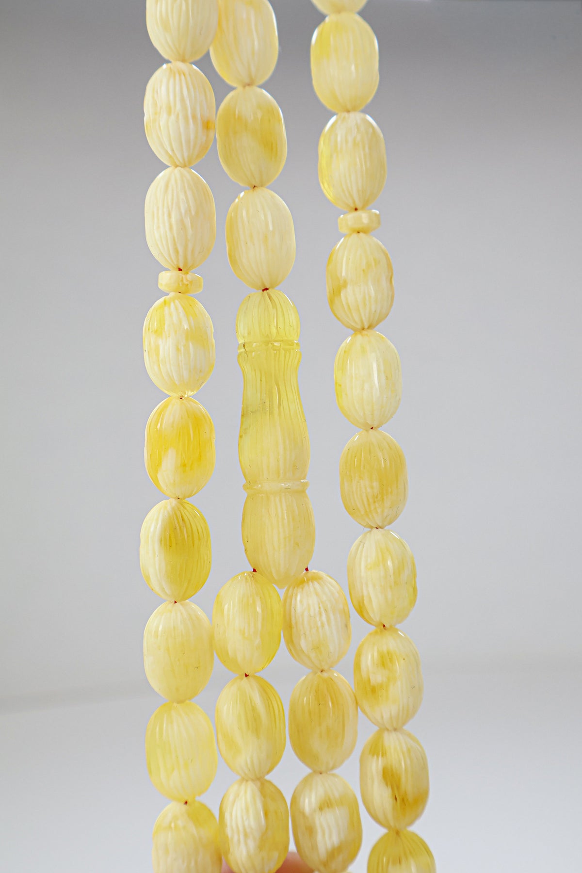 Certified hand-carved yellow and white Baltic amber misbaha rosary with 42 beads measuring 15.5x10.5 mm by Tetibel.