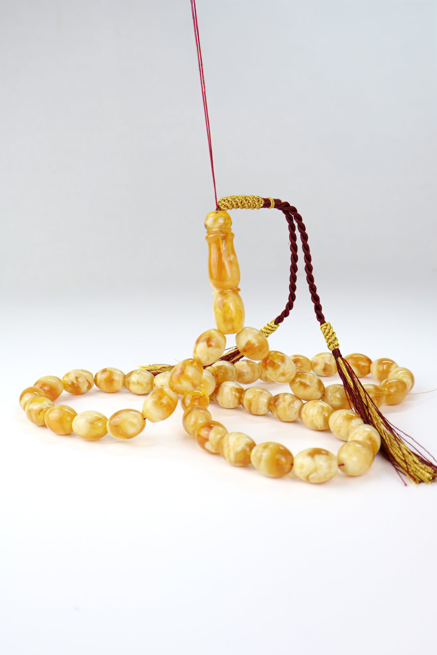 Pressed Baltic amber prayer beads 42 beads 15x12mm 59.66g with handmade burgundy and gold Doha Qatar tassel Tetibel Jewels