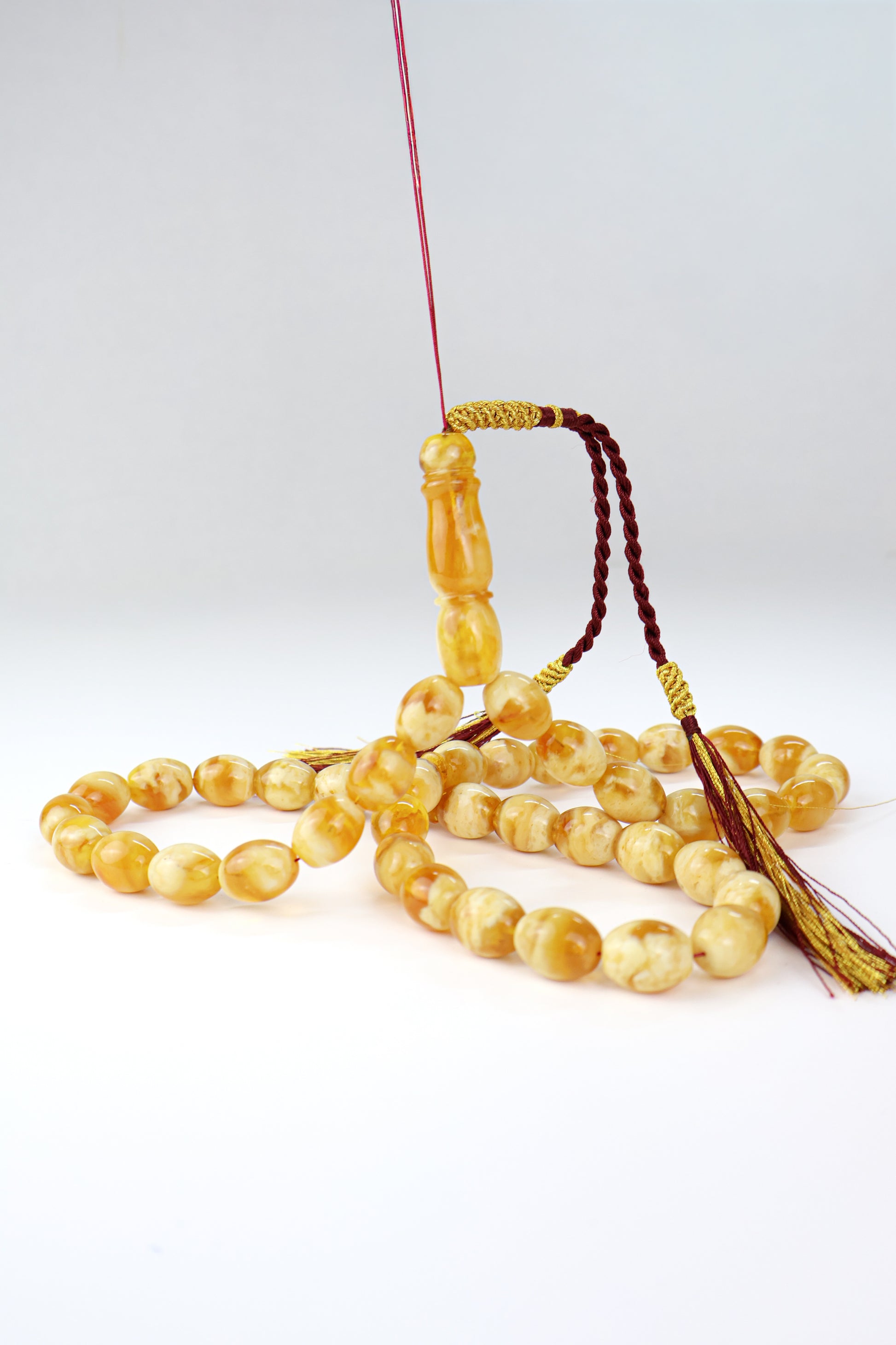 Pressed Baltic amber prayer beads 42 beads 15x12mm 59.66g with handmade burgundy and gold Doha Qatar tassel Tetibel Jewels