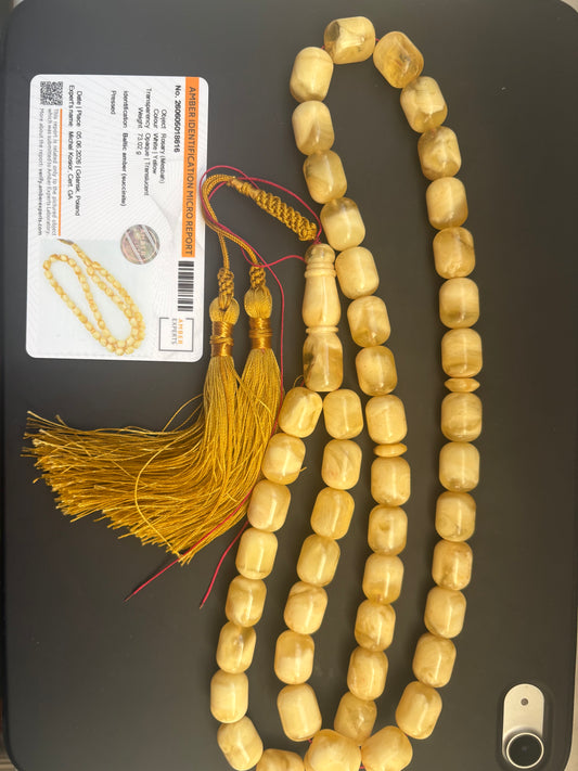 Tetibel 48-bead pressed Baltic amber rosary with 11.5x14.5mm white-yellow barrel beads and a handmade golden tassel from Doha.