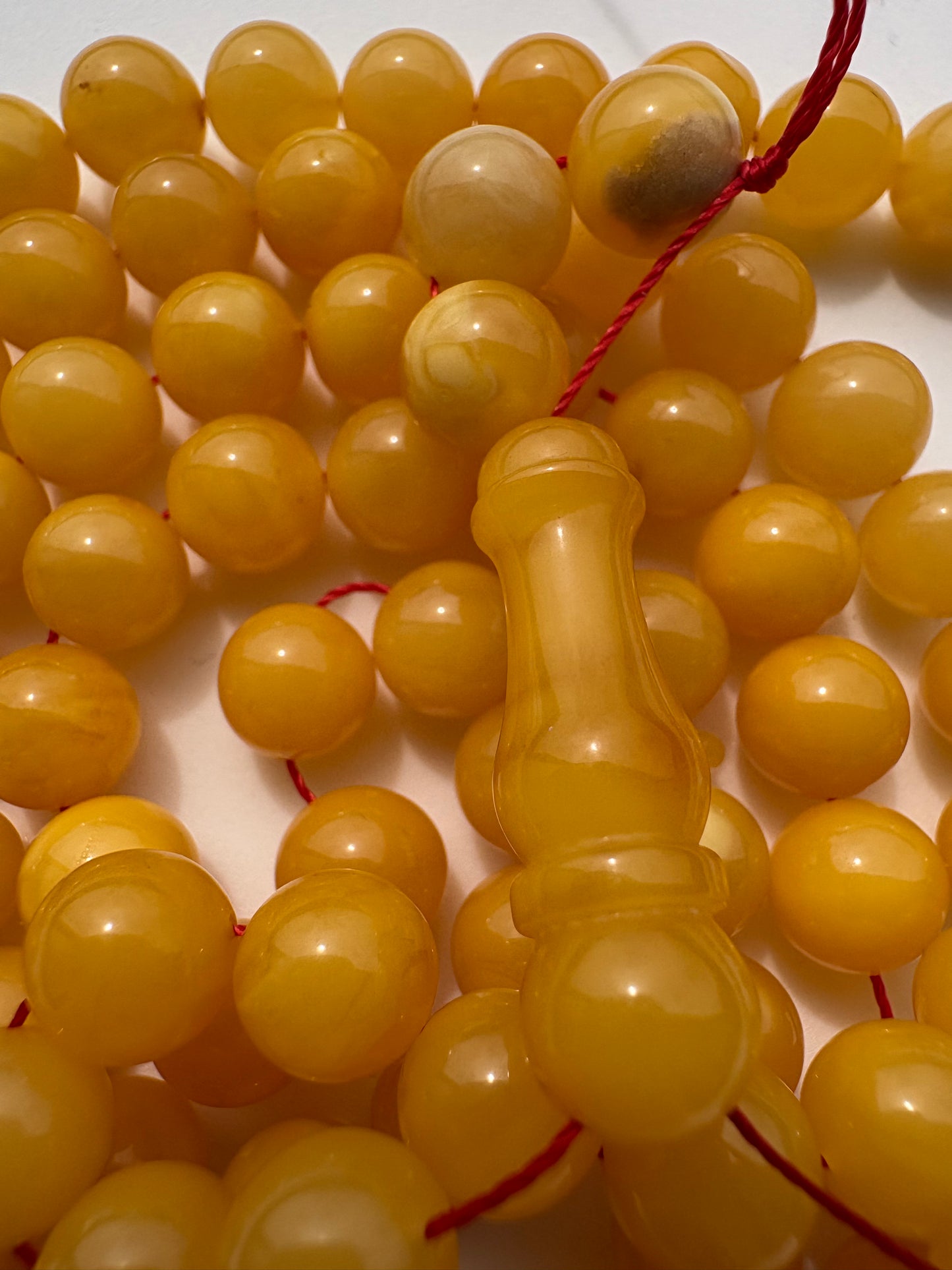 Collector-grade mango amber prayer beads with certificate of authenticity.