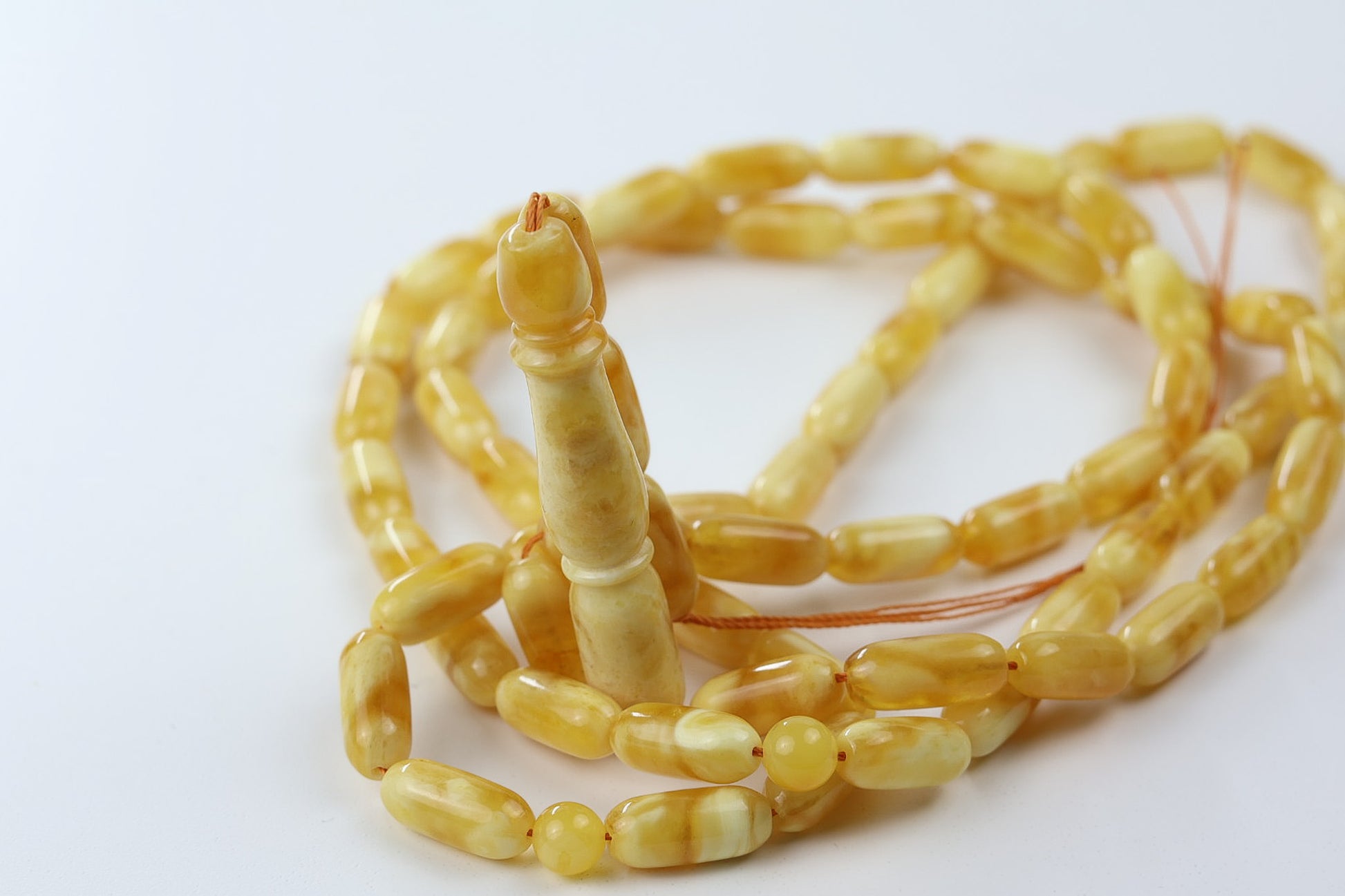Tetibel pressed amber rosary with butterscotch yellow oval beads and elongated imam piece, Islamic prayer beads handmade for Germany and European market.