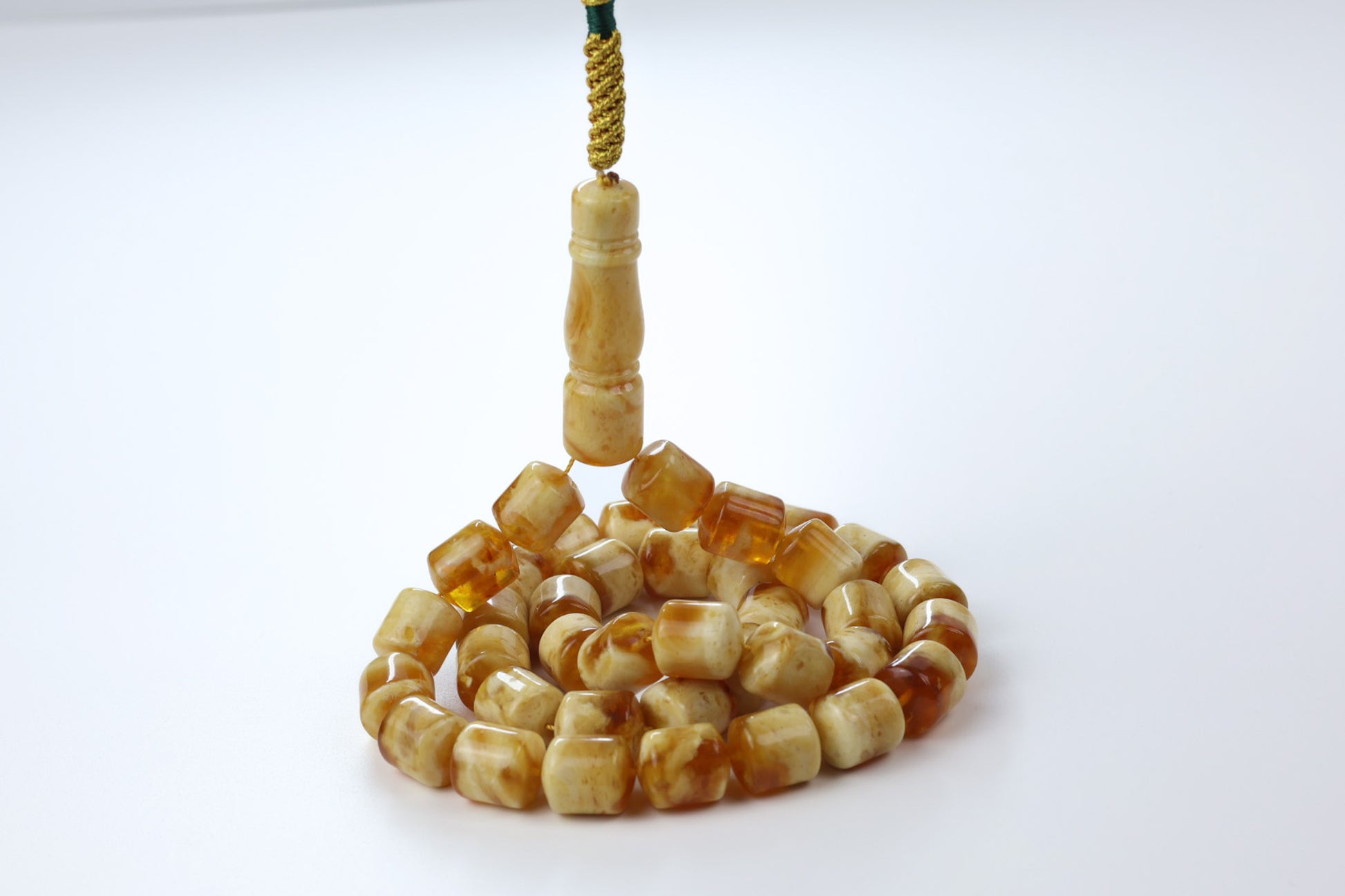 Pressed amber rosary with cube beads in honey and cognac tones, handcrafted Tesbih with green cord detail.