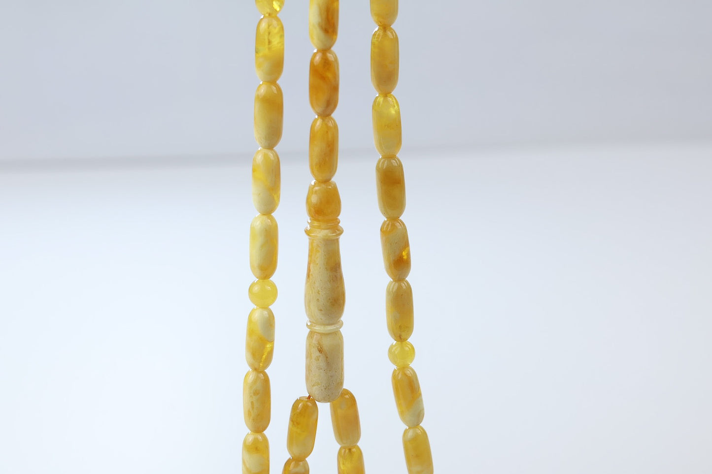 Butterscotch pressed amber misbaha by Tetibel featuring smooth oval beads and handcrafted imam piece, luxury Islamic prayer beads Germany.