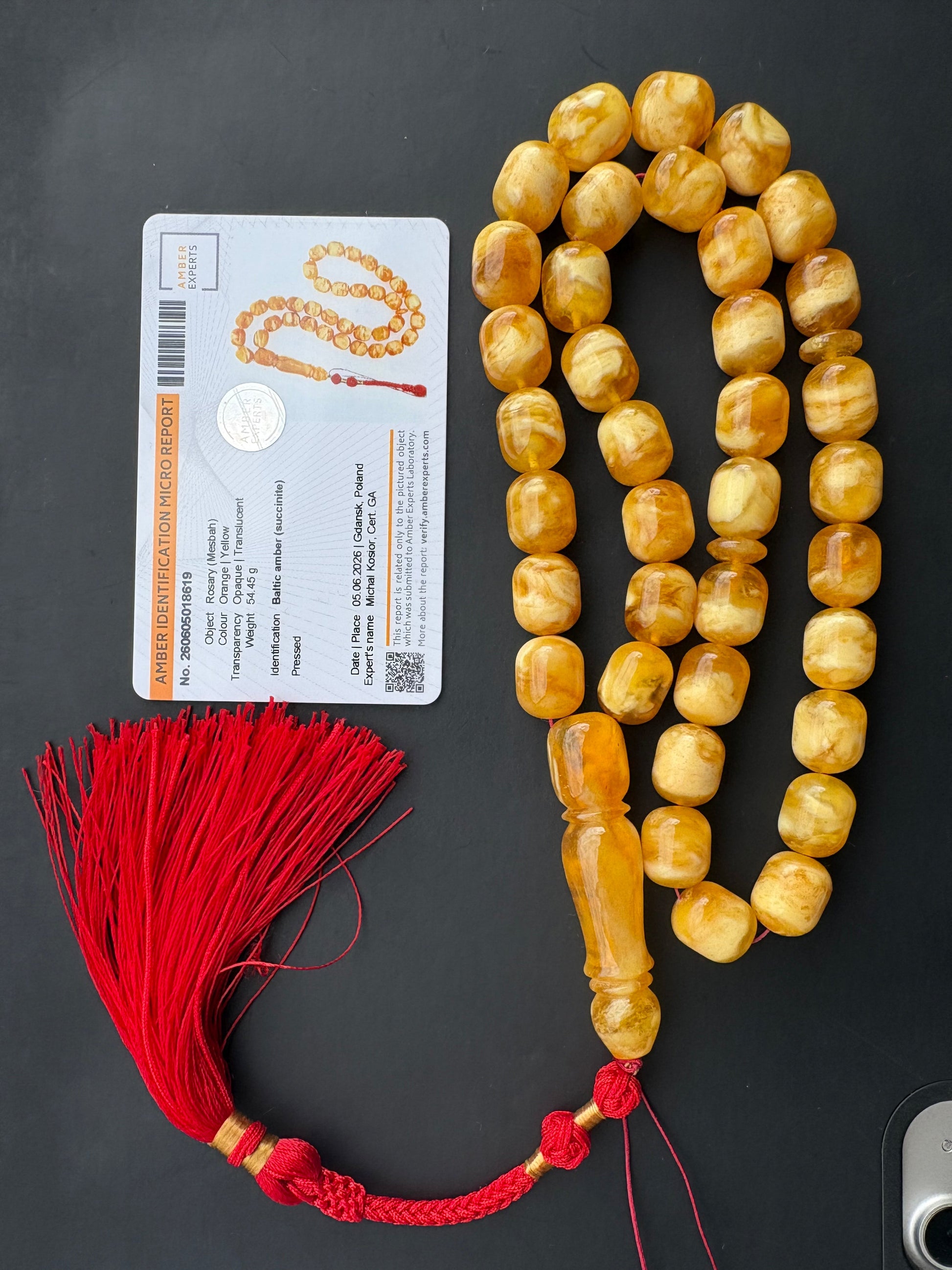 Tetibel 36-bead pressed Baltic amber rosary with 14x11.5mm orange-yellow oval beads and a handmade bright red tassel from Doha.