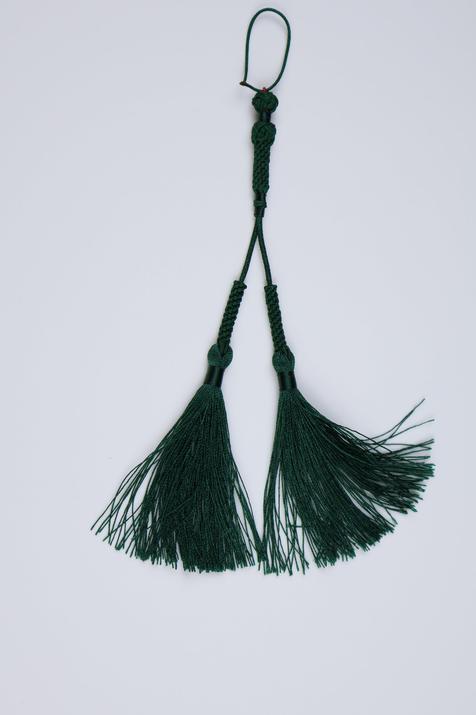 Dark green tassels with braided cords and hanging loops, idea for amber mesah